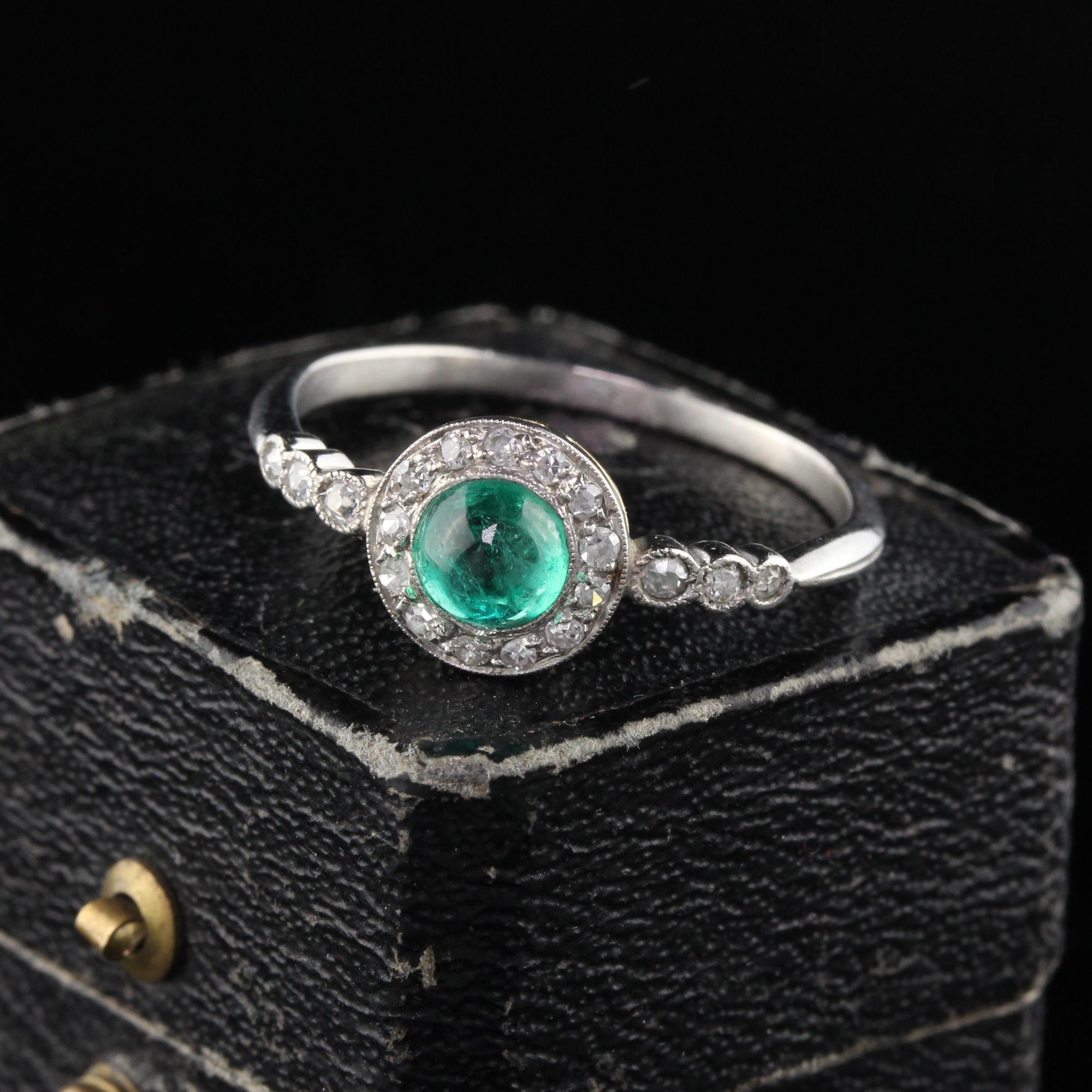 Simply beautiful French Edwardian Engagement Ring featuring a cabochon emerald surrounded by a thin halo of diamonds and 3 stones on either side. Dainty and elegant. Sits very low to the finger.

#R0272

Metal: Platinum

Weight: 2.4 Grams

Center