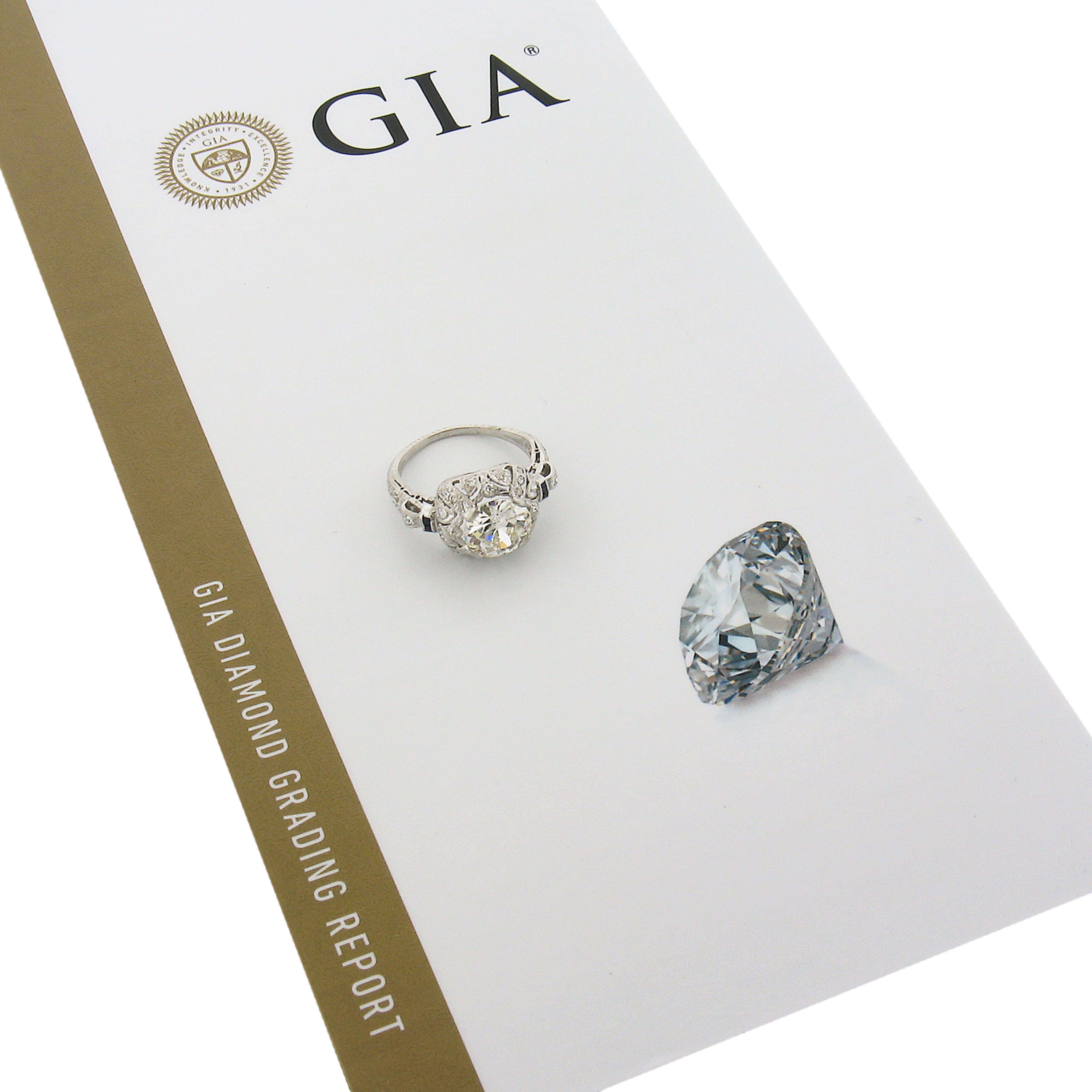 This antique Edwardian engagement ring is crafted in solid platinum and features a gorgeous, GIA certified old cut diamond neatly set at the center squared setting. This stunning large center diamond is full of character and reflects the light