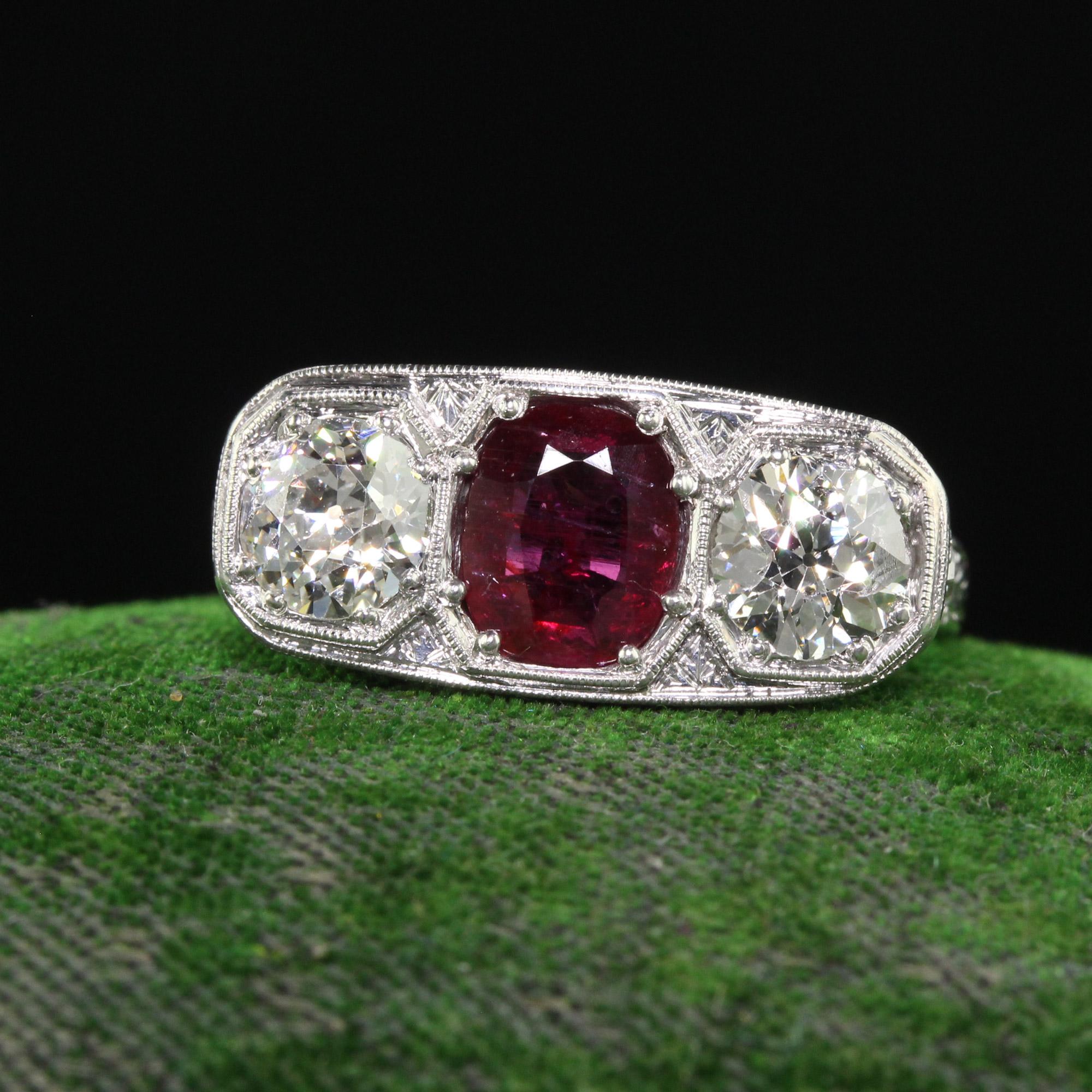 Beautiful Antique Edwardian Platinum Old Euro Diamond and No Heat Ruby Three Stone Ring. This incredible Edwardian three stone ring is crafted in platinum. The ring features a natural no heat ruby in the center that has a GIA report and two old