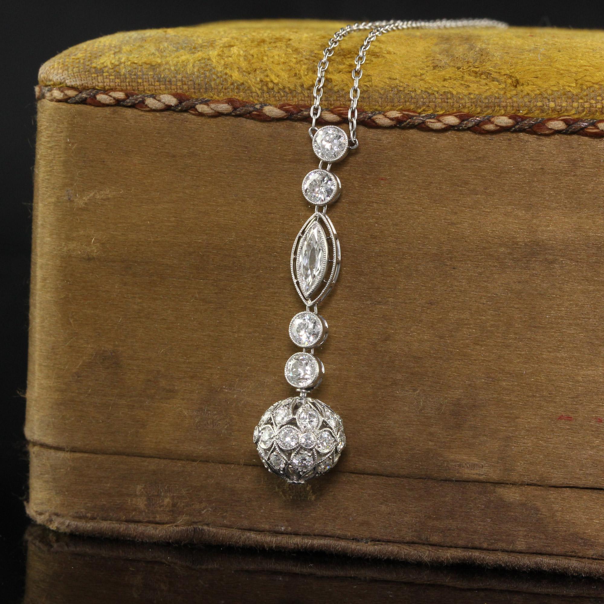 Beautiful Antique Edwardian Platinum Old Euro Diamond Drop Pendant Necklace. This gorgeous drop pendant necklace is crafted in platinum. The pendant has old European cut diamonds and an old marquise in the center. The ball on the bottom of the