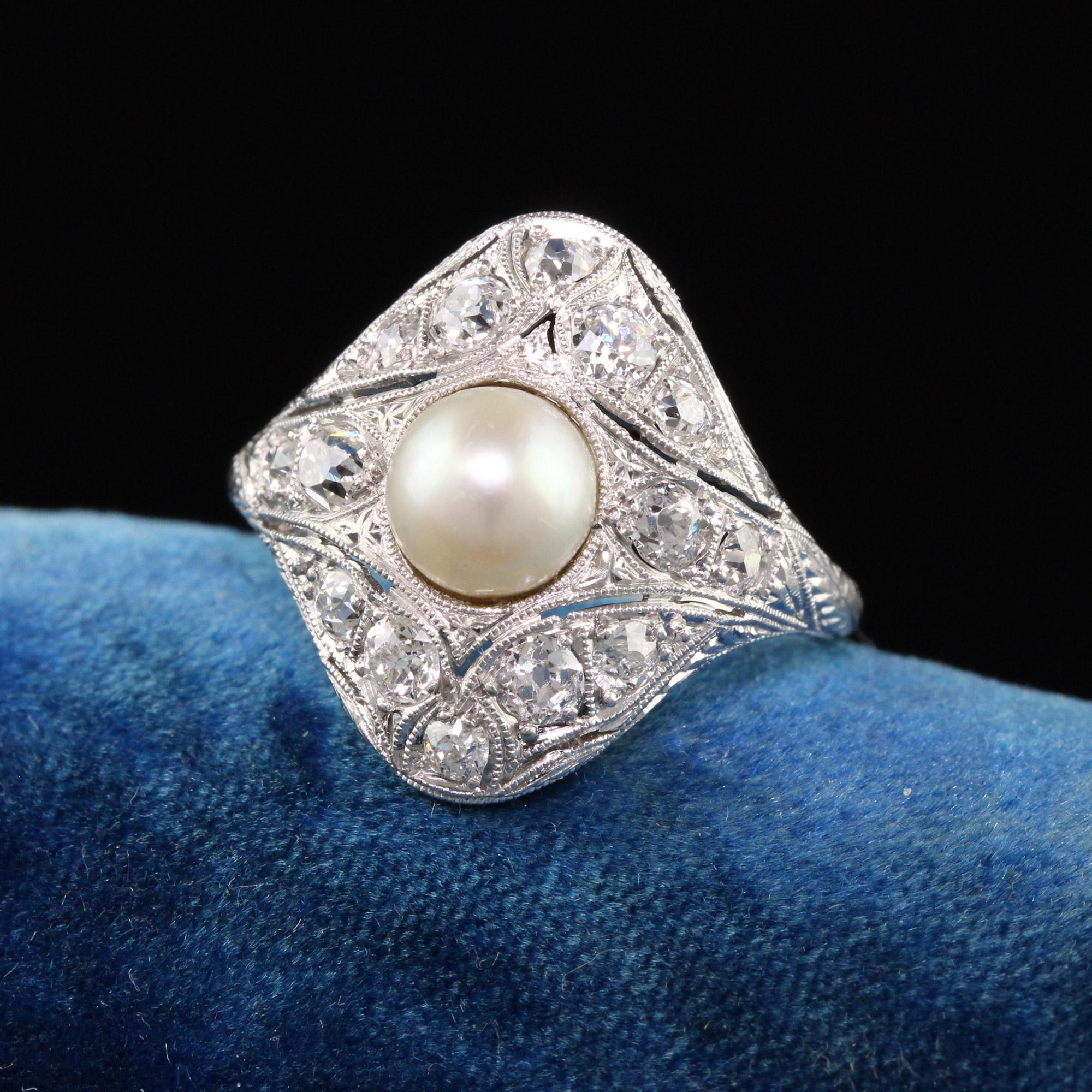 Beautiful Antique Edwardian Platinum Old European Diamond Pearl Engagement Ring. This gorgeous Edwardian ring features old european cut diamonds with amazing milgraining alongside a white pearl in the center that is believed to be natural.

Item