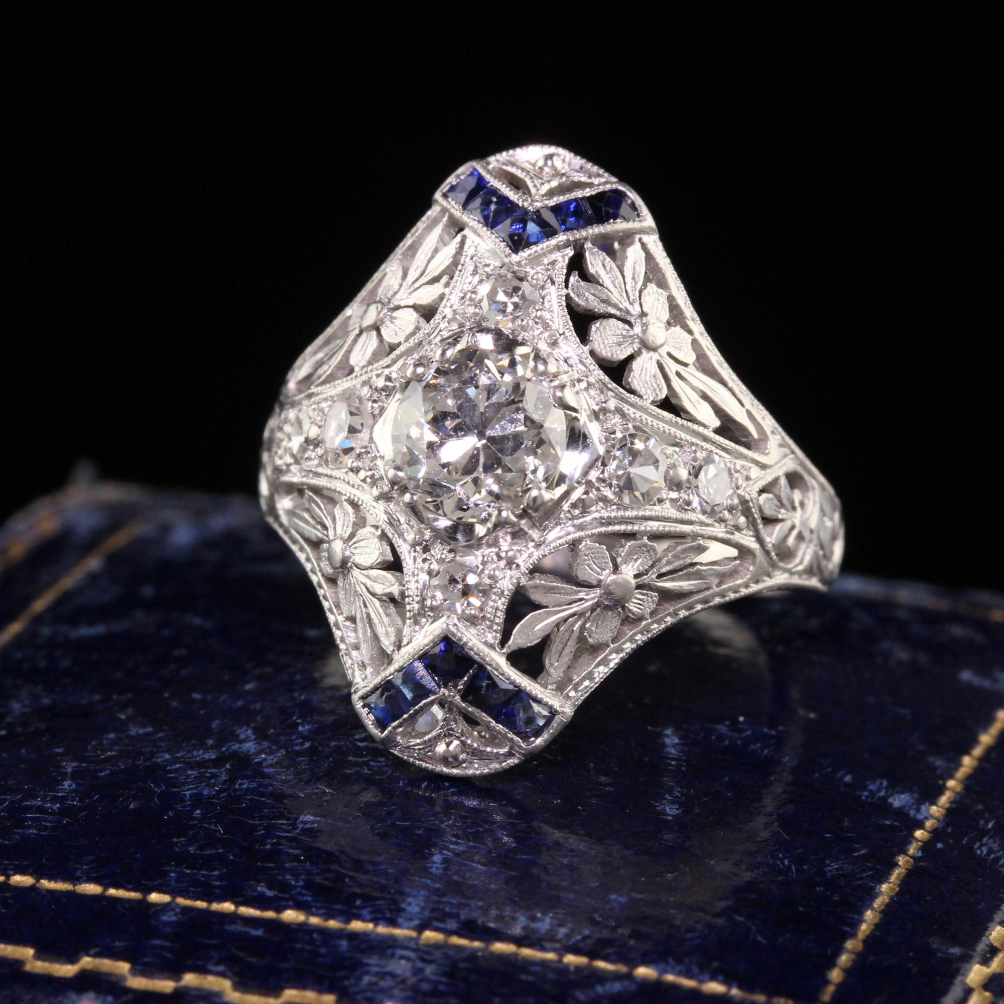 Beautiful Antique Edwardian Platinum Old European Diamond Sapphire Shield Ring. This incredible ring is crafted in platinum. The center holds an old european cut diamond that has a GIA report. Is also has gorgeous blue sapphires and single cut