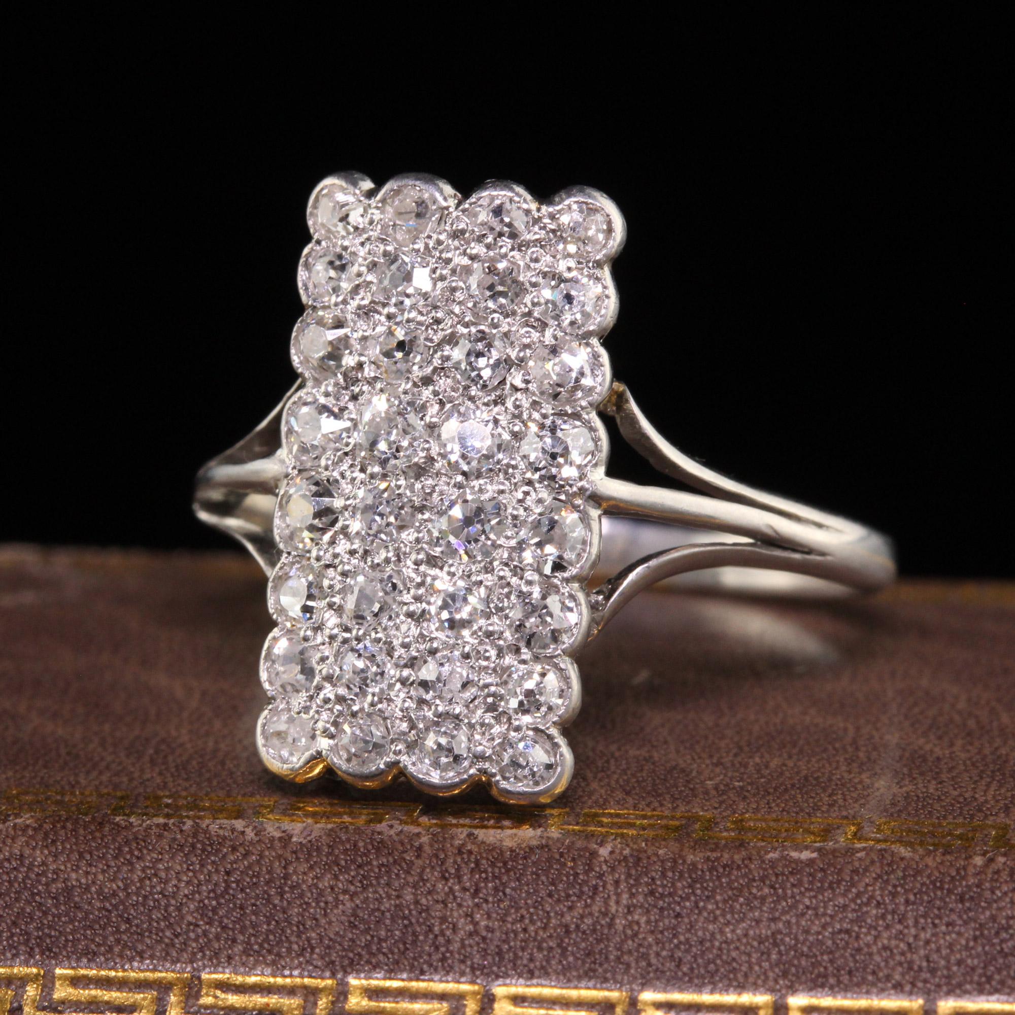 Beautiful Antique Edwardian Platinum Old Mine Cut Diamond Pave Shield Ring. This incredible shield ring is crafted in platinum. The ring holds chunky old cut diamonds that are set flush on top of the ring. The ring is in great condition with a few