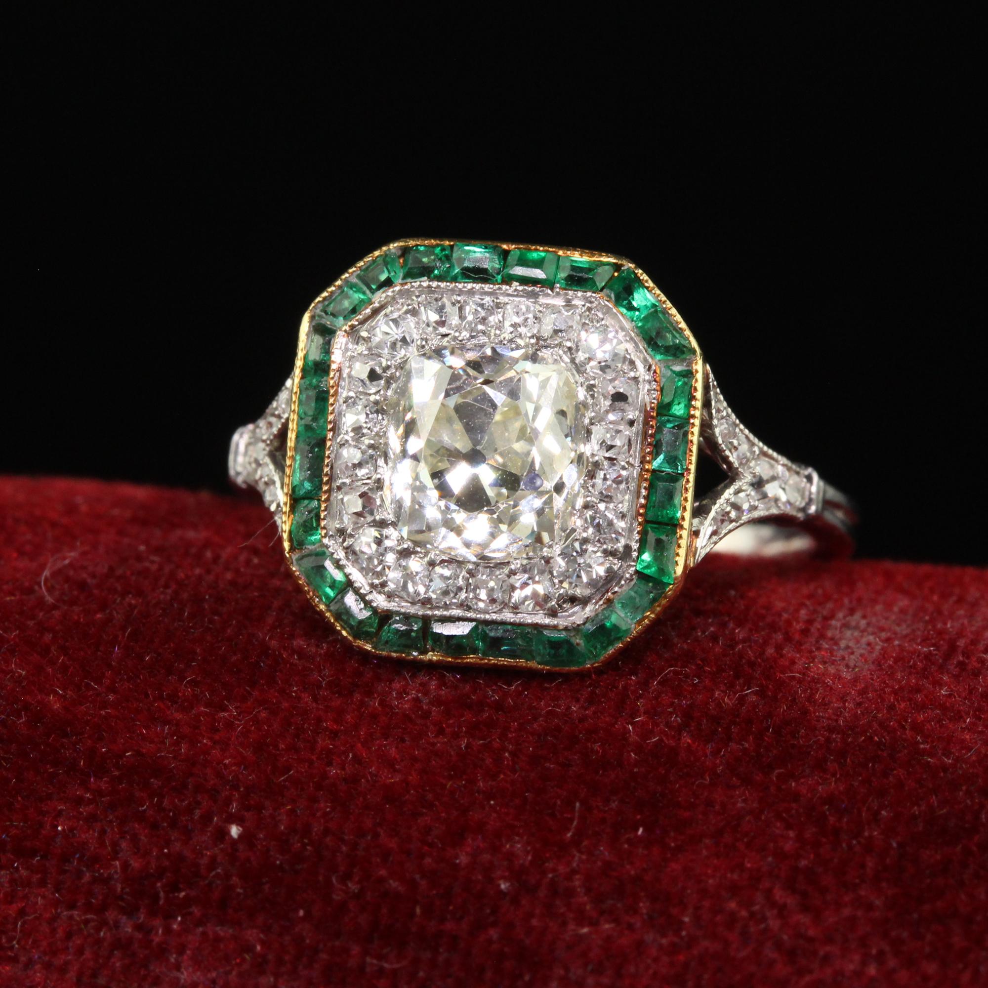 Beautiful Antique Edwardian Platinum Old Mine Diamond and Emerald Engagement Ring. This incredible Edwardian old mine diamond engagement ring is crafted in platinum and 18k yellow gold. The center holds a chunky old mine cut diamond that is