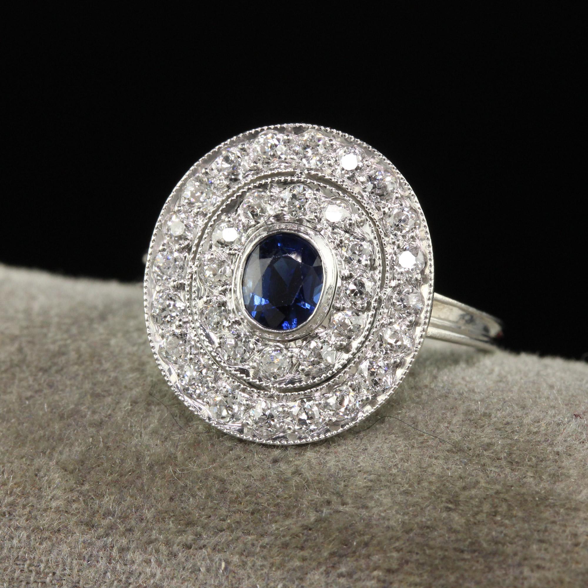 Beautiful Antique Edwardian Platinum Old Mine Diamond and Sapphire Engagement Ring. This gorgeous engagement ring is crafted in platinum. The center holds a natural blue sapphire in the center and has two rows of old mine cut diamonds going around
