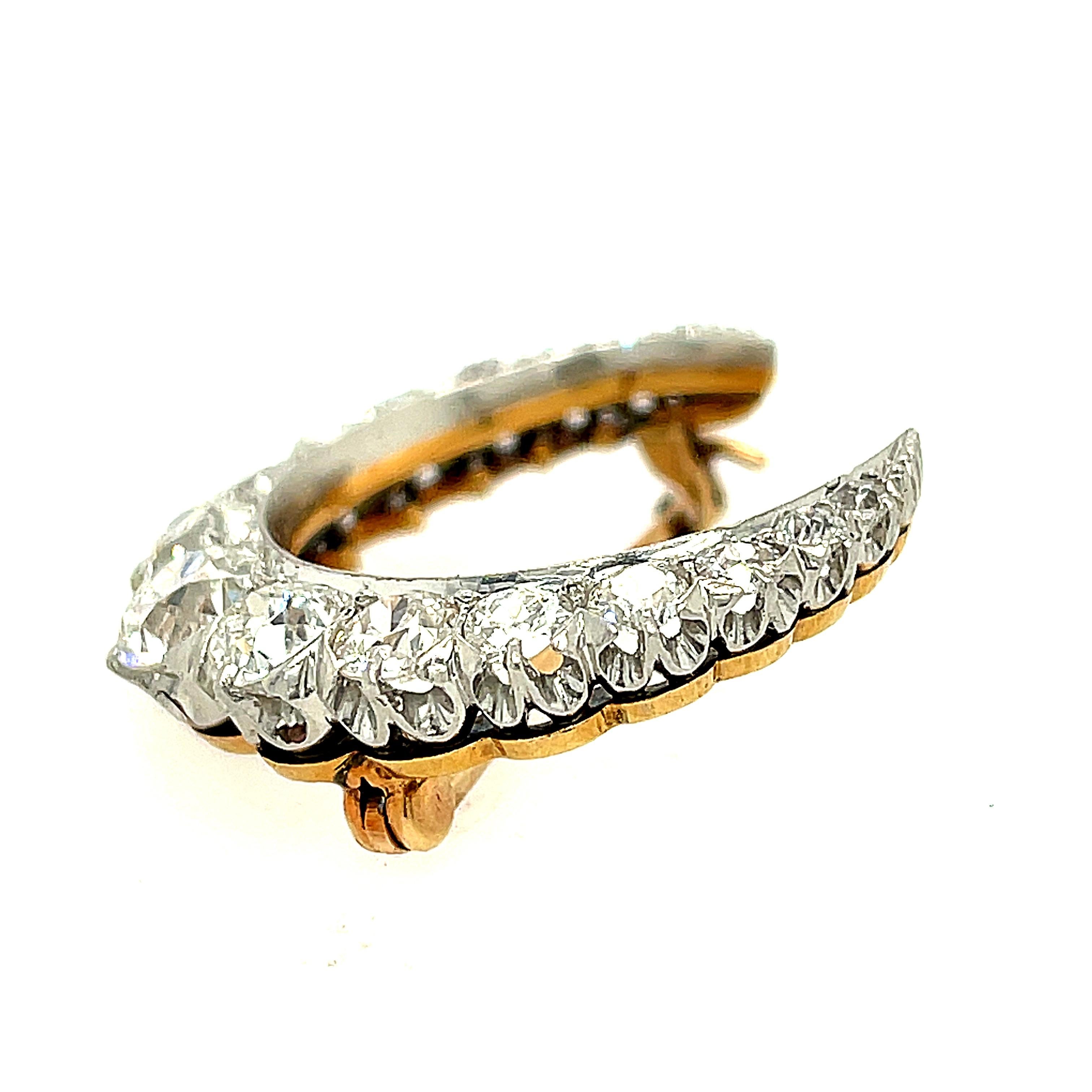 A pristine antique Edwardian platinum topped gold crescent pin set with Old European cut diamonds, circa 1900. The diamonds in this pin are white and clean, approximately G to H color and VS clarity. The total weight of the diamonds are 2.85 carats