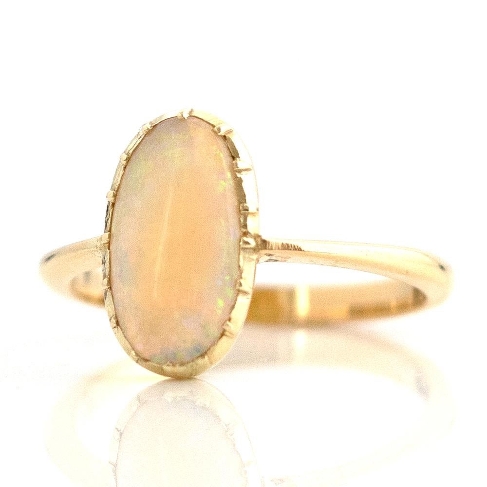Our antique Edwardian Opal 18ct gold ring is elegance and sophistication. Expertly handmade in 18ct gold featuring a oval precious opal. The opal has a magnificent play of colour which comes alive when it catches the light as you move. Opals
