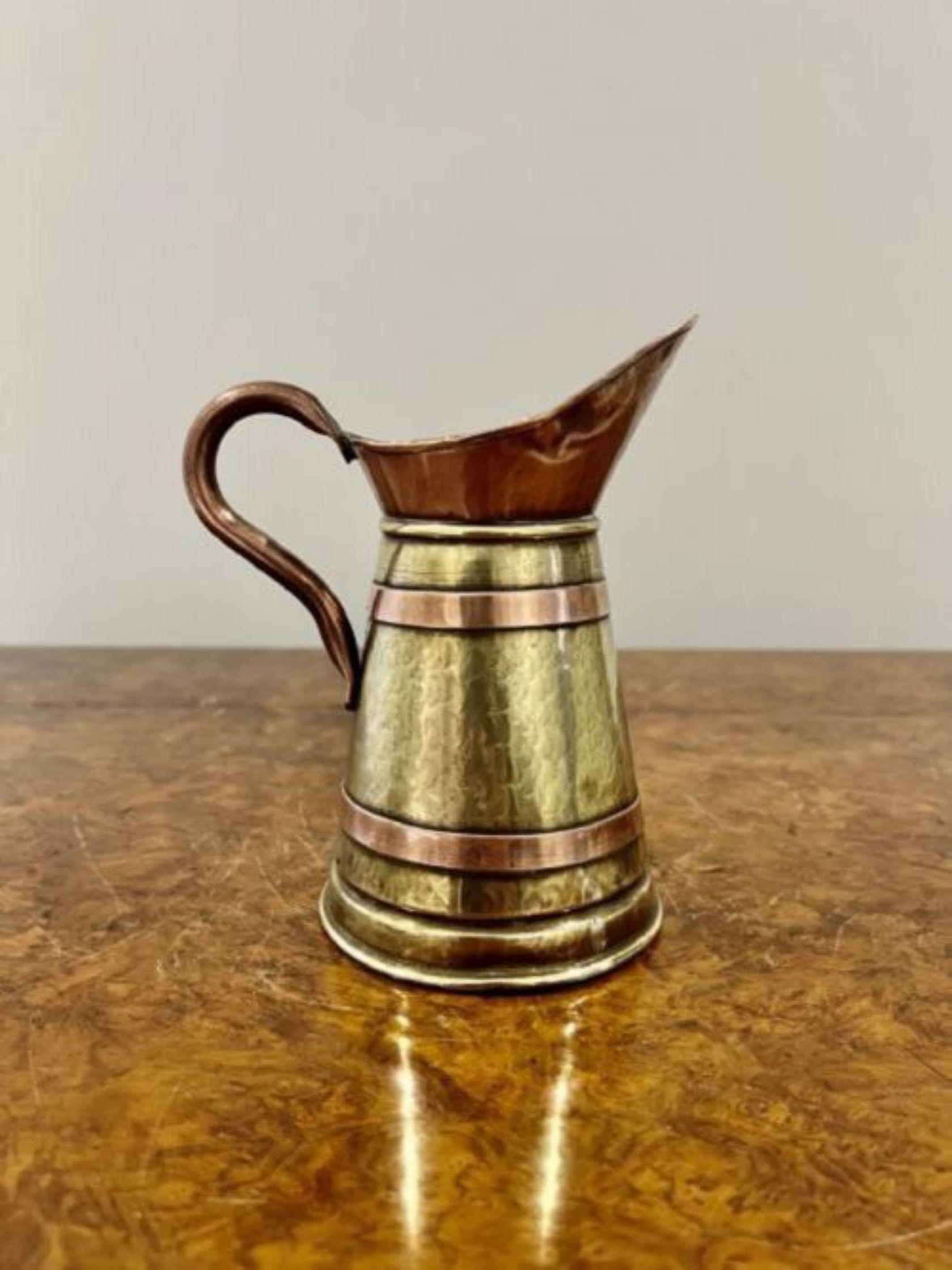 Antique Edwardian quality brass and copper jug having a quality shaped copper handle and copper bounds around a brass engraved jug 