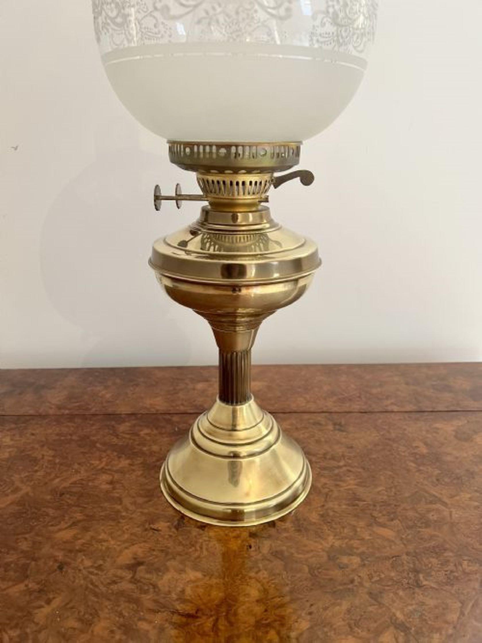 Antique Edwardian quality brass and glass oil lamp having the original white coloured patterned glass shade above a brass front on a turned shaped pedestal base
