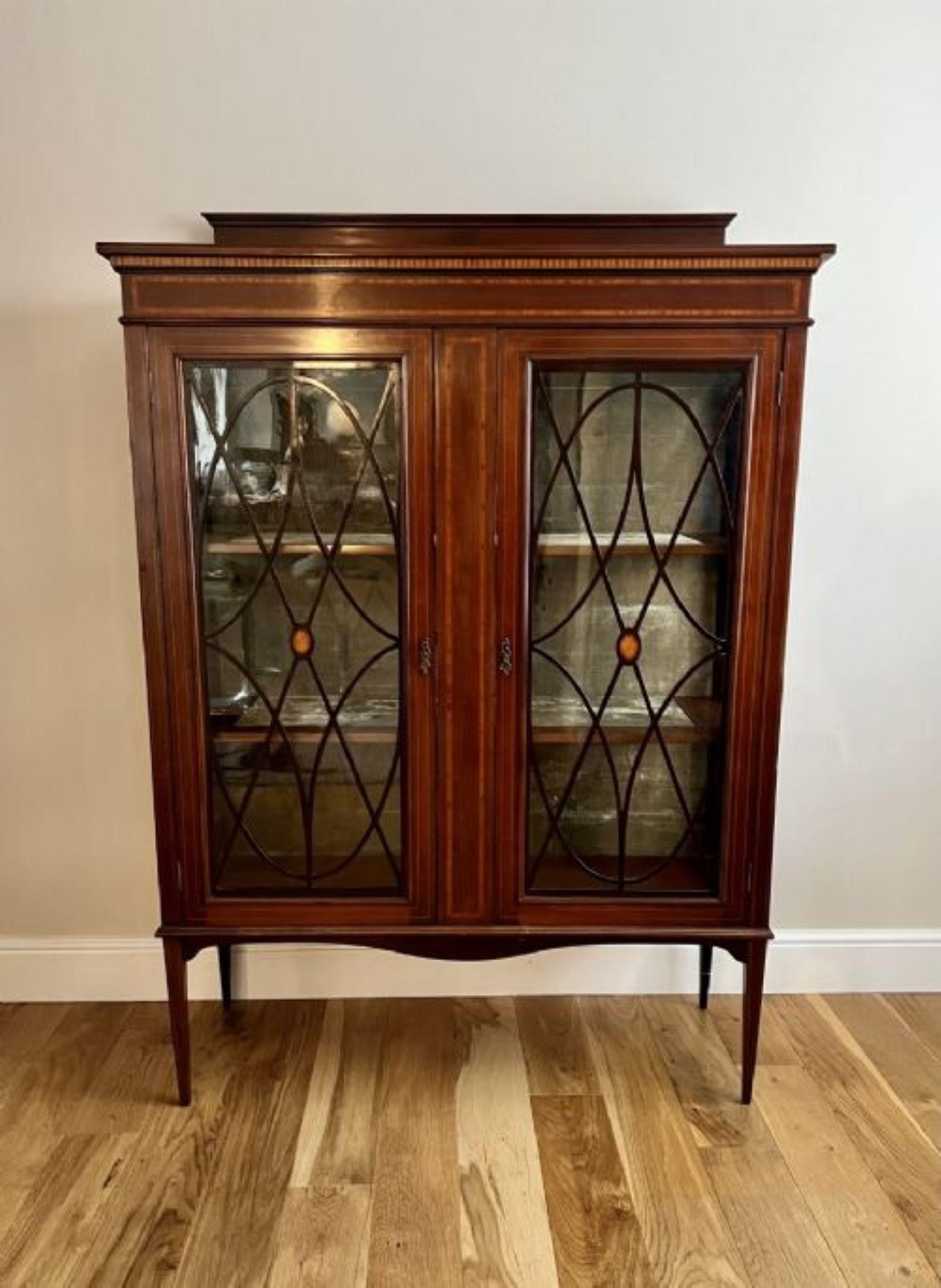 Antique Edwardian quality inlaid mahogany display cabinet having a quality mahogany display cabinet with satinwood inlay with a pair of astral glazed doors opening to reveal two display shelves with the original velvet lining standing on square