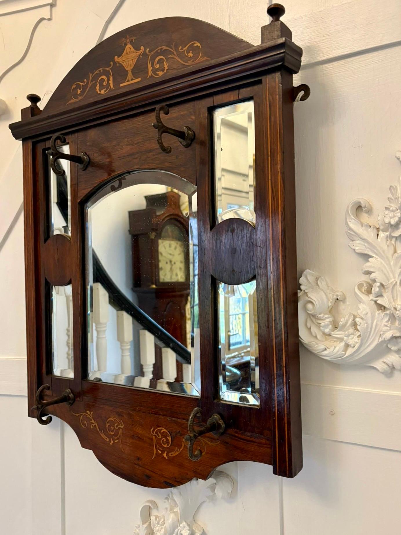 Antique Edwardian quality inlaid rosewood wall/hall mirror having 5 bevelled edge mirrors in a quality inlaid rosewood frame with 4 original irons hooks for hats.

An unusual and desirable piece ideal for a hallway or entrance.

Dimensions:
Height