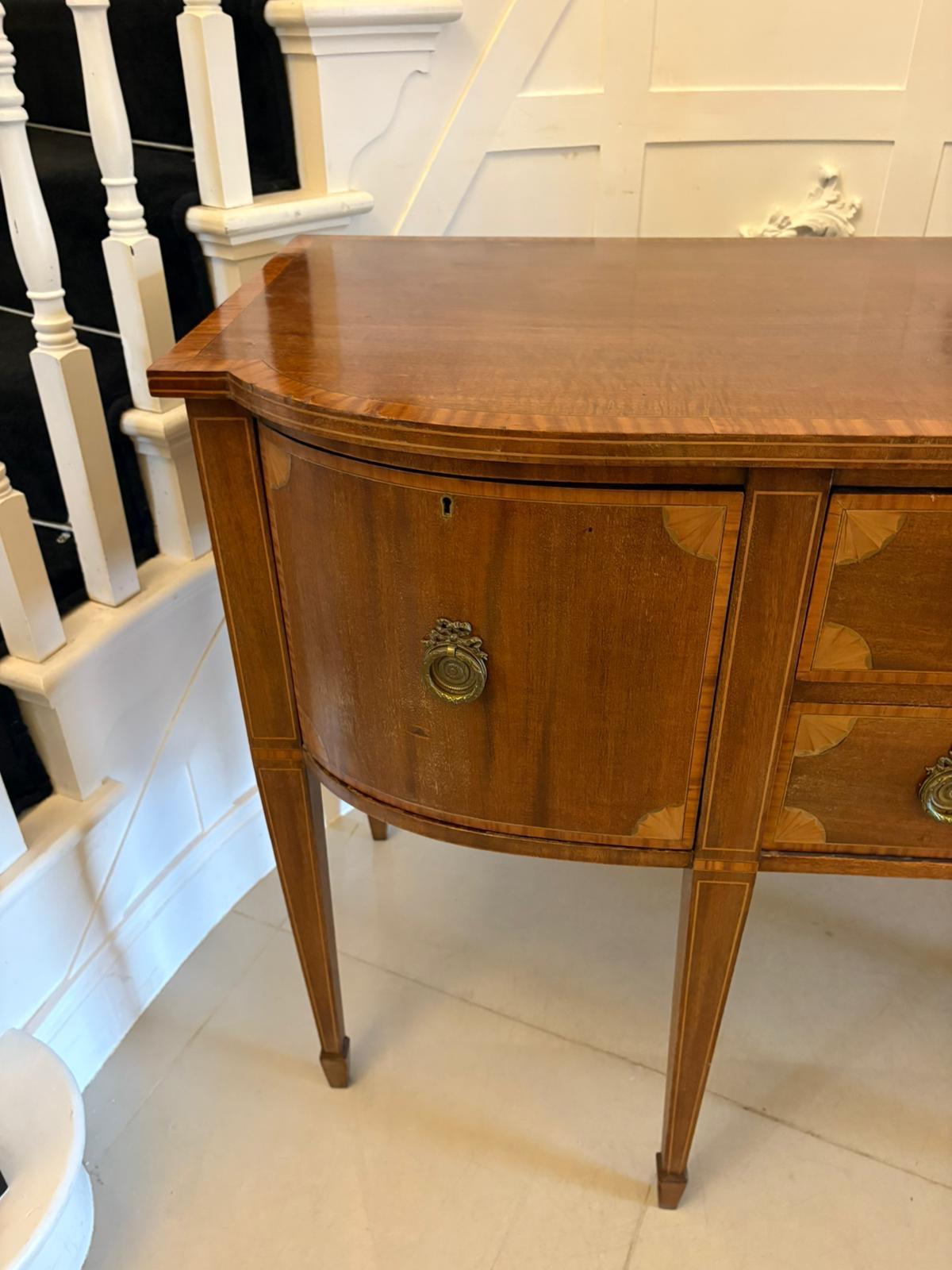 Antique Edwardian quality mahogany and satinwood crossbanded sideboard having a quality figured mahogany and satinwood crossbanded top above two drawers flanked by two shaped doors with satinwood shell inlay and original ornate brass handles