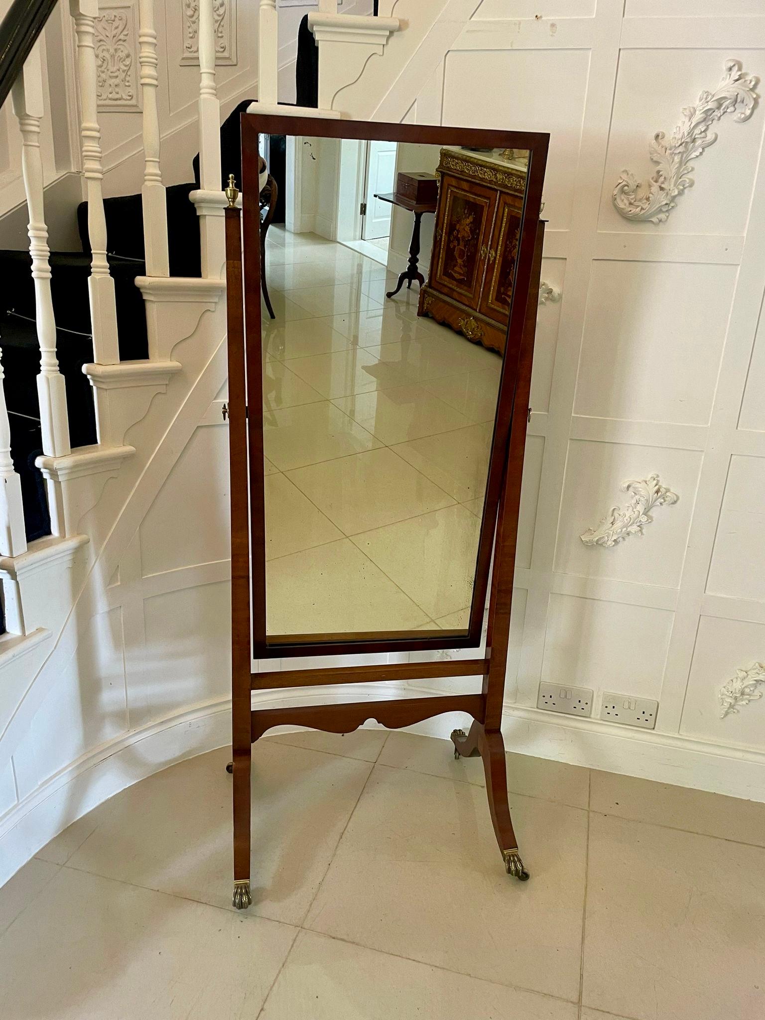 Antique Edwardian quality mahogany free standing cheval mirror having the original adjustable swing mirror in a quality mahogany free standing frame supported by square mahogany columns with brass finales standing on sabre legs with brass claw feet