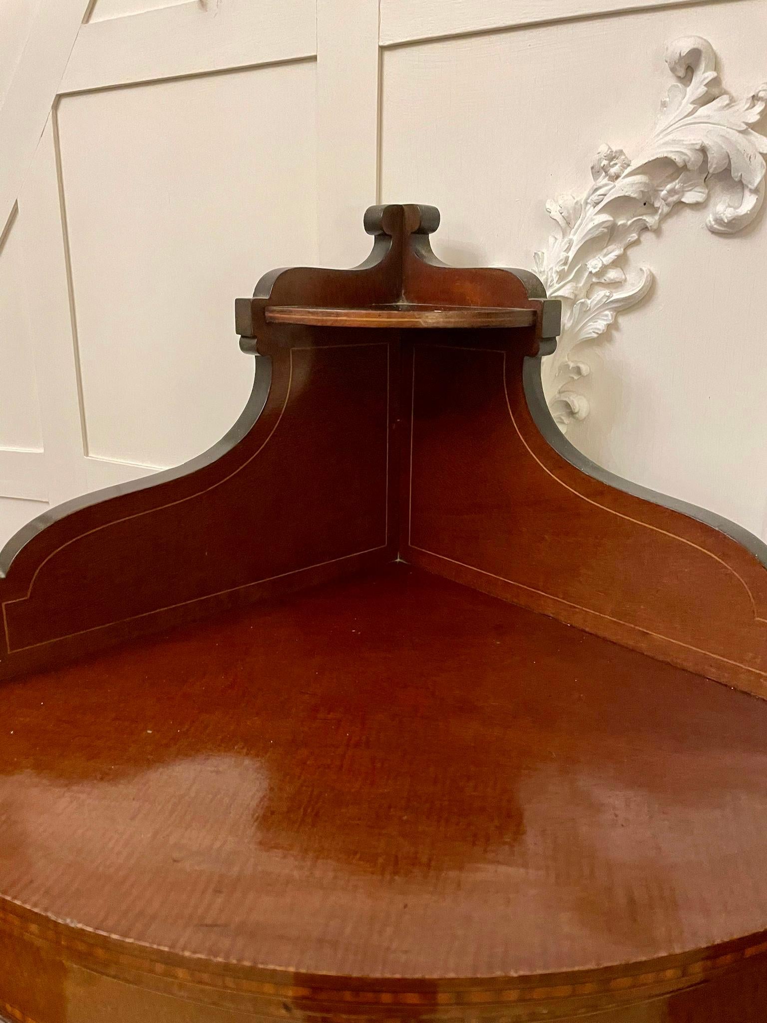 Antique Edwardian quality mahogany inlaid bow fronted corner display cabinet having a pretty shaped gallery top above a mahogany and satinwood inlaid bow fronted single glazed door opening to reveal a velvet lined shelf interior and standing on