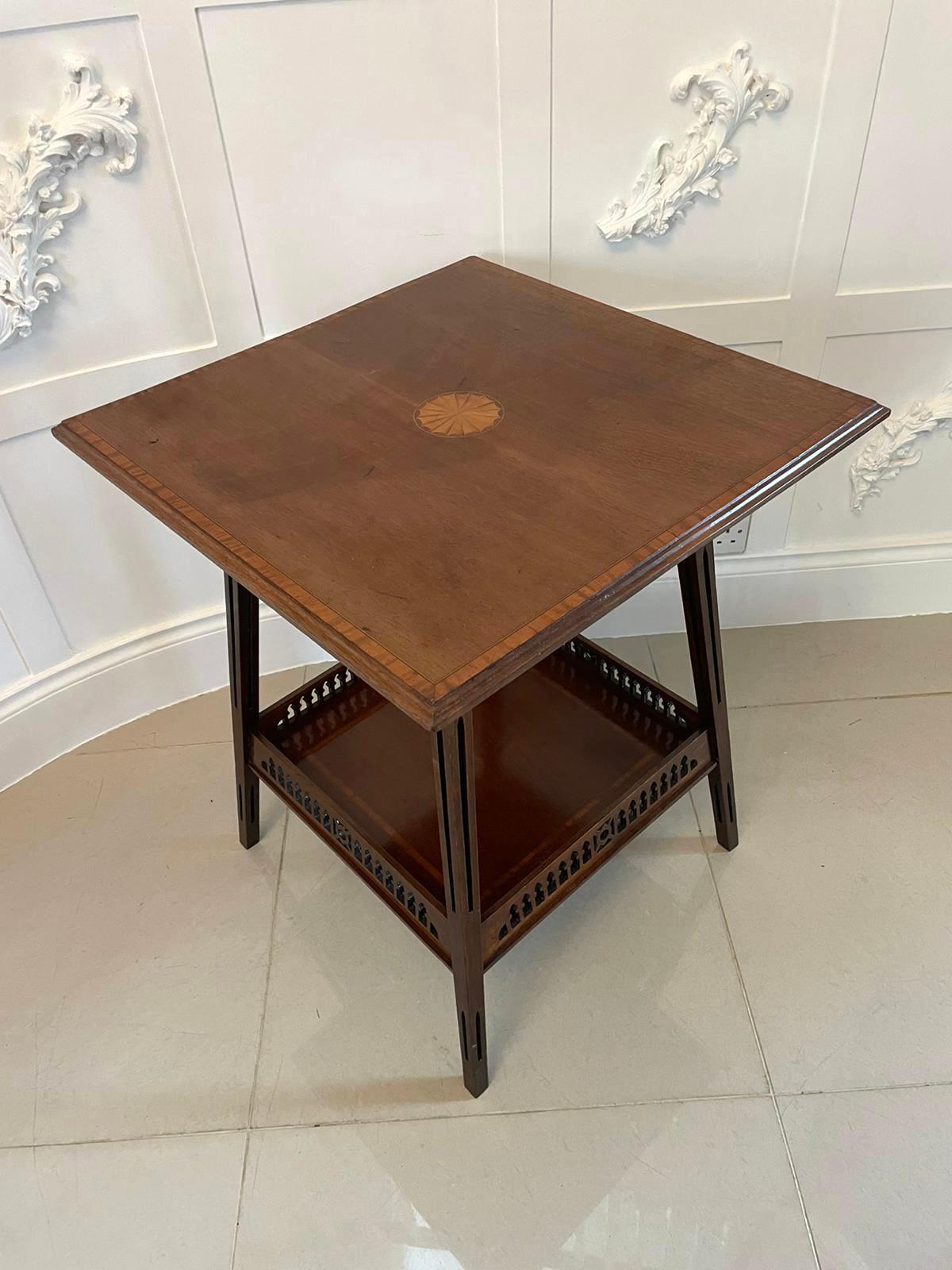 Antique Edwardian quality mahogany inlaid centre table having a quality mahogany top crossbanded in satinwood with a satinwood inlaid shell to the centre, mahogany frieze standing on four square tapering legs with carved pierced fretwork united by a