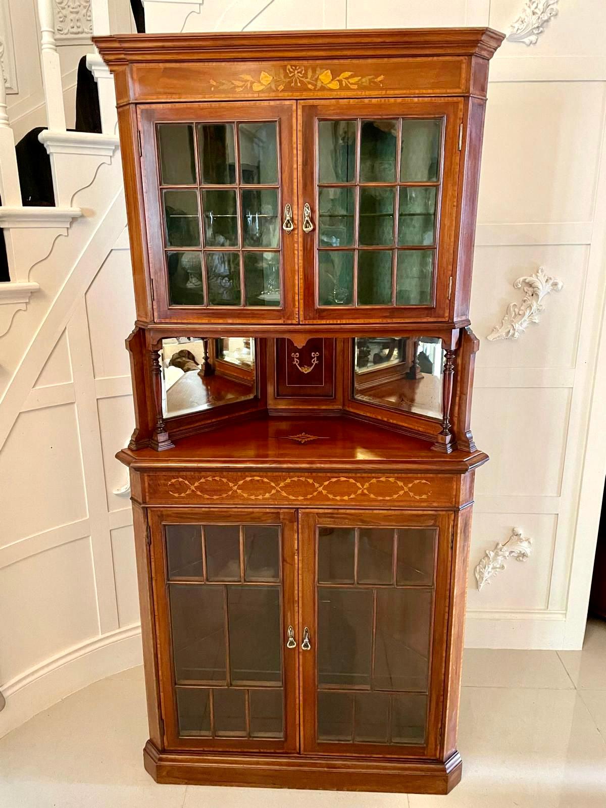 Antique Edwardian quality mahogany inlaid corner display cabinet having a shaped cornice above an attractive quality marquetry inlaid frieze. It boasts a pair of mahogany inlaid astral glazed doors with original brass handles opening to reveal an