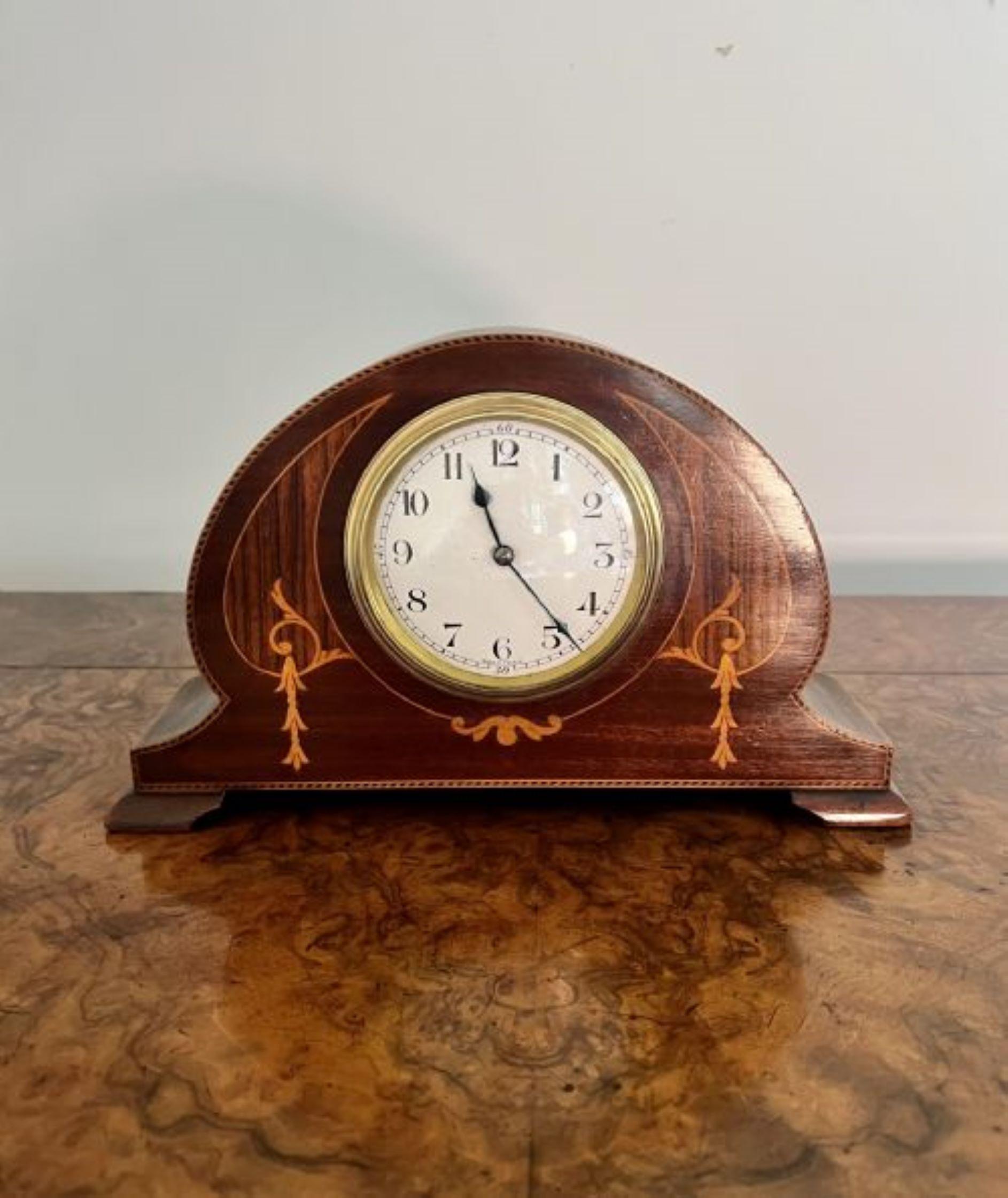 Antique Edwardian quality mahogany inlaid desk clock having a quality mahogany inlaid beautifully shaped case, with a white porcelain dial and brass bezel, having the original hands with an eight day movement, standing on four shaped feet. 
Please