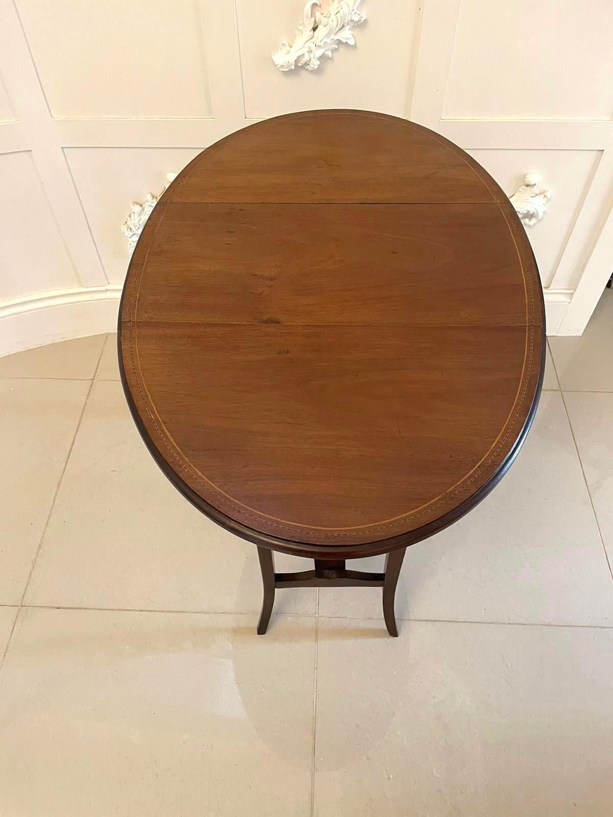 Antique Edwardian quality mahogany inlaid lamp table having a quality mahogany inlaid swing round top with two drop leaves and a moulded edge. It stands on four square tapering shaped mahogany legs united by a shaped mahogany undertier.

A
