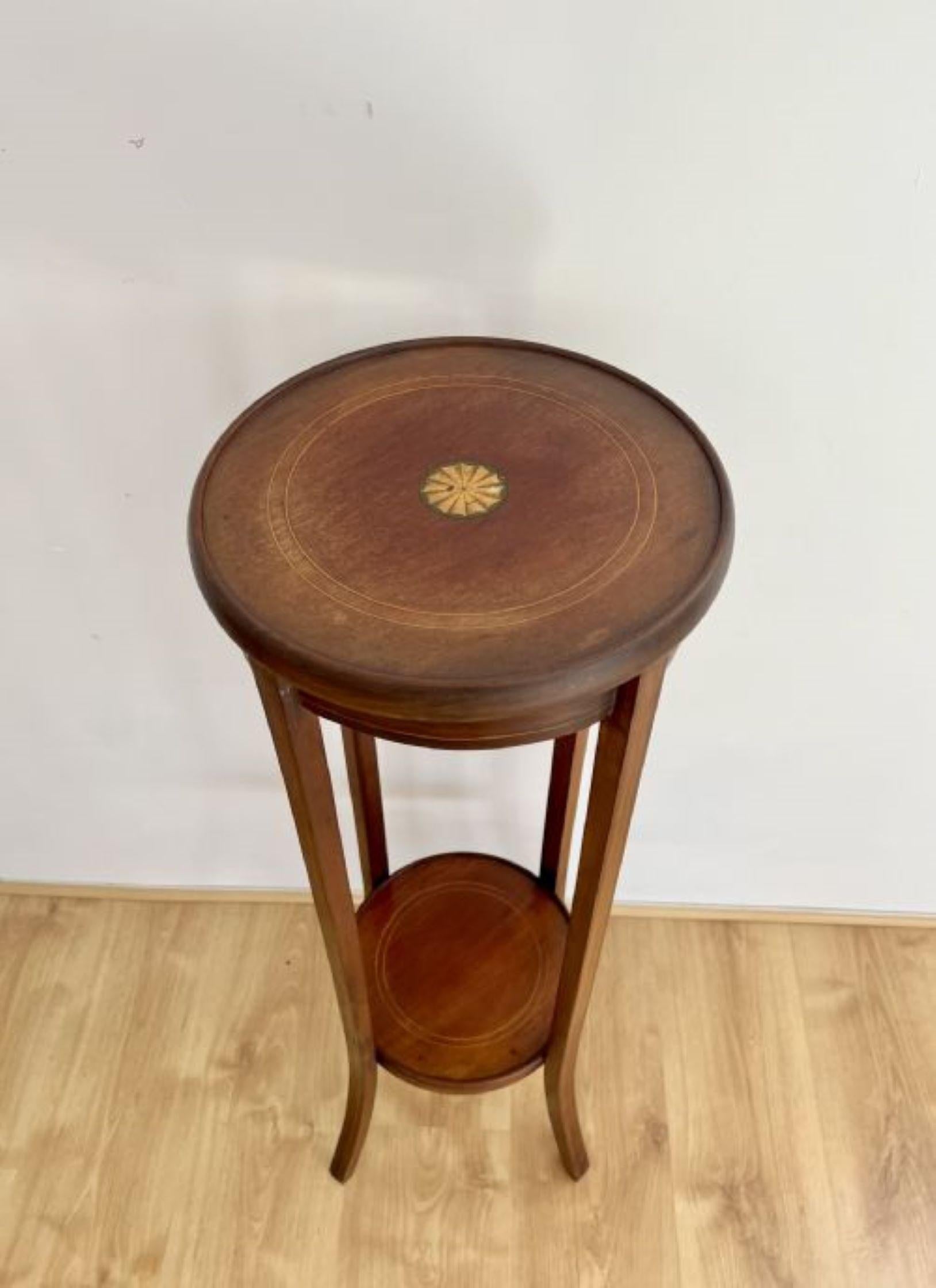 Antique Edwardian quality mahogany inlaid plant stand having a quality antique Edwardian mahogany plant stand with satinwood inlaid stringing and a satinwood inlaid shell to the centre of the circular top, standing on four elegant tapering legs