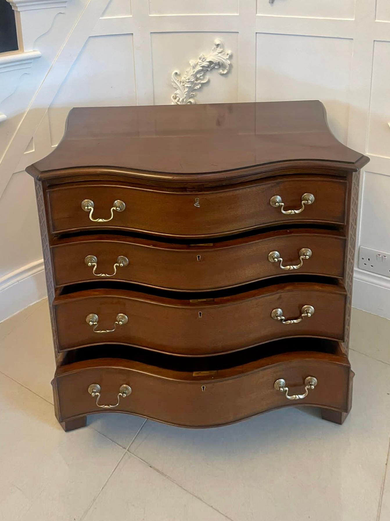 Antique Edwardian quality mahogany serpentine shaped chest of 4 drawers having a quality mahogany serpentine shaped top with a moulded edge above 4 serpentine shaped cockbeeded drawers with original brass swan neck handles, carved canted corners