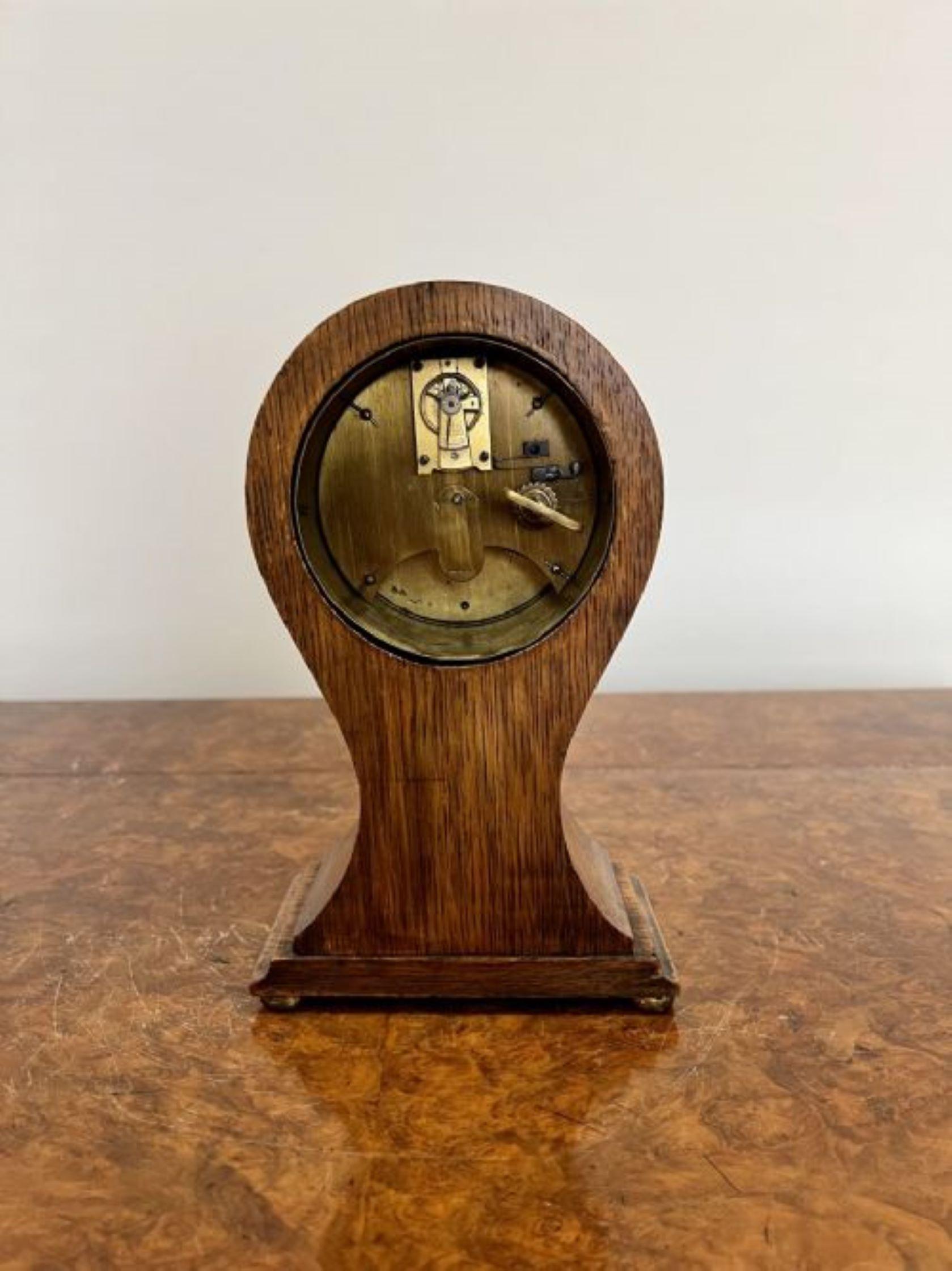 Antique Edwardian quality oak and fan marquetry inlaid balloon shaped mantle clock having a quality oak balloon shaped case with a white enamel dial and Arabic numerals raised on bun feet
Please note all of our clocks are serviced prior to delivery