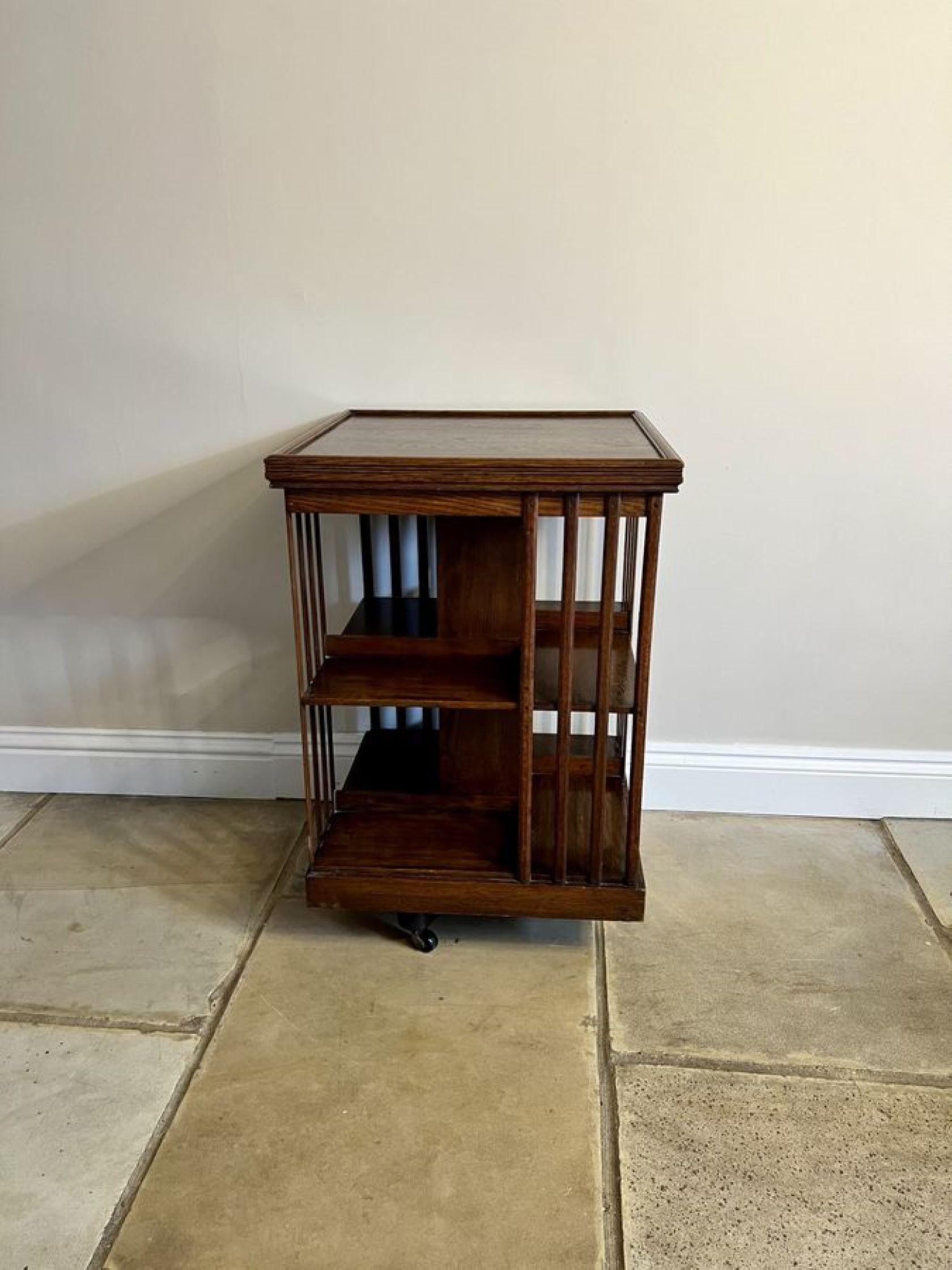 Antique Edwardian quality Oak revolving bookcase having a quality top with a moulded edge, supported by oak reeded splats and has eight open book shelves supported by a plinth base raised on a revolving oak cross stretcher with the original