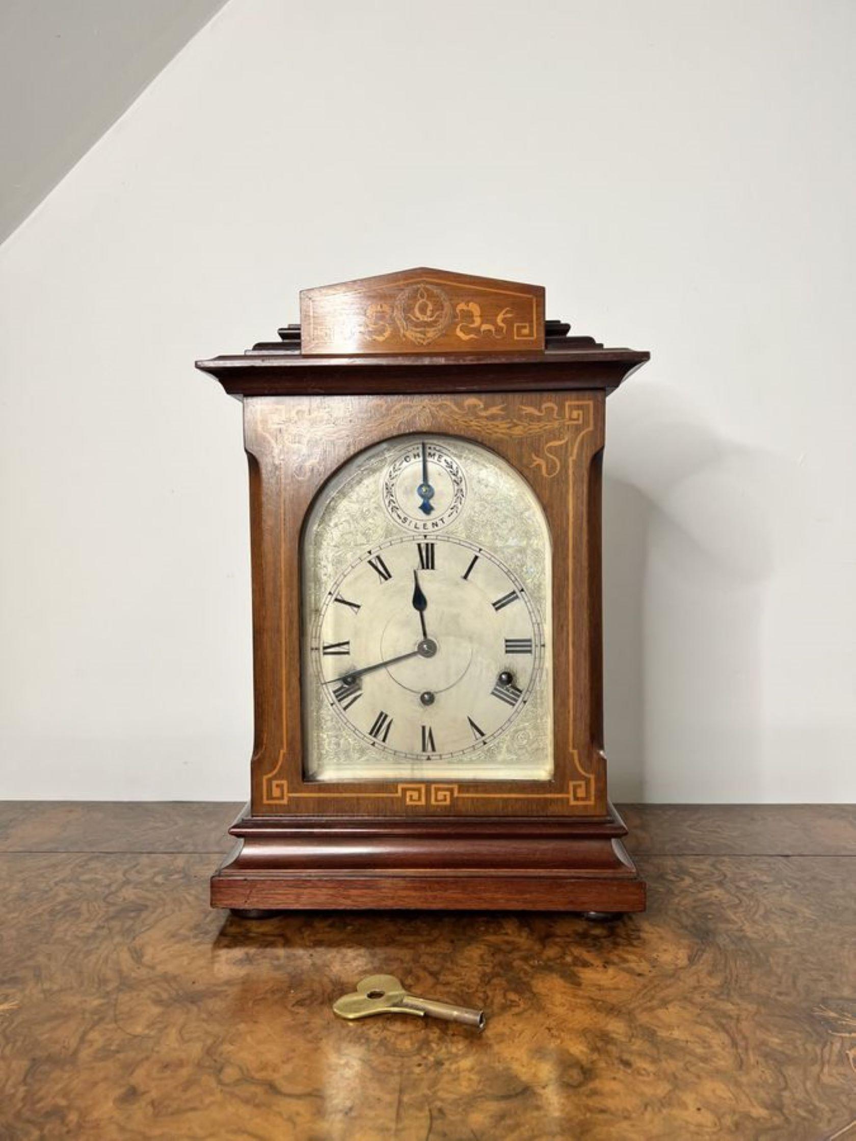 Antique Edwardian quality rosewood inlaid chiming 8 day mantle clock having a quality rosewood inlaid case, a single glazed door to the front of the case with a working lock to the side, a silvered dial, with a 8 day striking movement chiming the