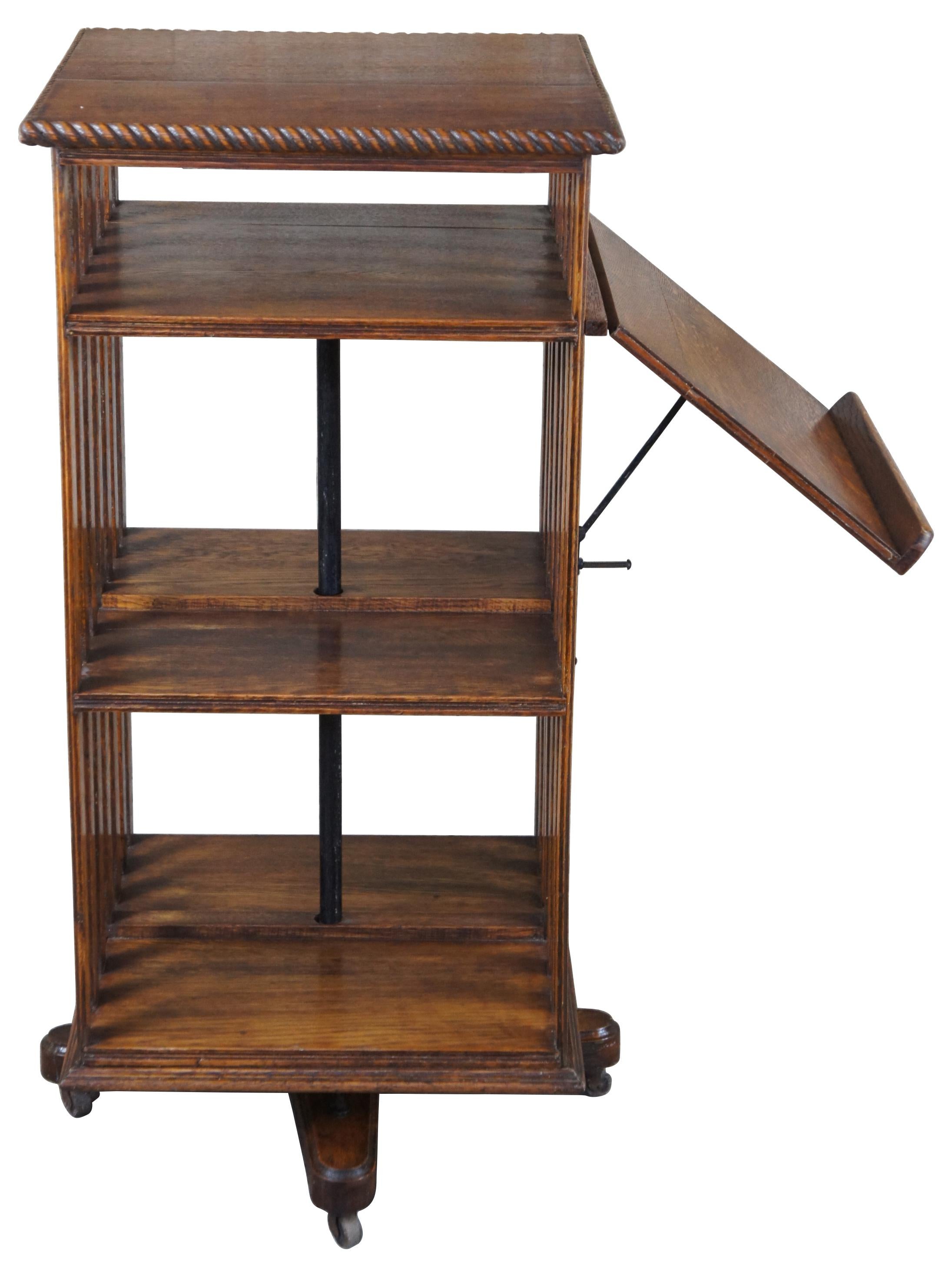 Antique Edwardian / Victorian revolving / rotating library bookcase or pedestal book stand. Made of quartersawn oak featuring mission / arts and crafts styling with slatted sides, rope twist edge and rare folding lectern attachment.

Measures: