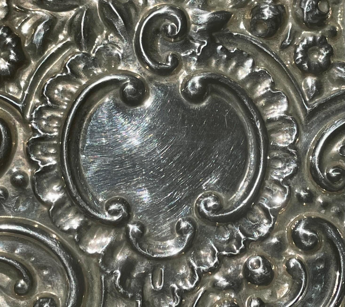 Anglais Antique Repousse Sterling Silver Bevelled Edge Mirror. en vente