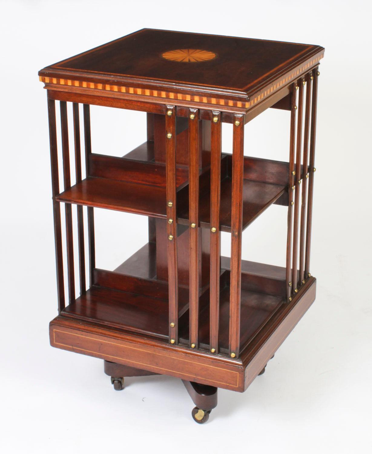 This an exquisite antique revolving bookcase  attributed to the renowned Victorian retailer and manufacturer Maple & Co., circa 1900.

It is made of mahogany , revolves on a solid cast iron base, has inlaid boxwood lines to the top and bottom,  the