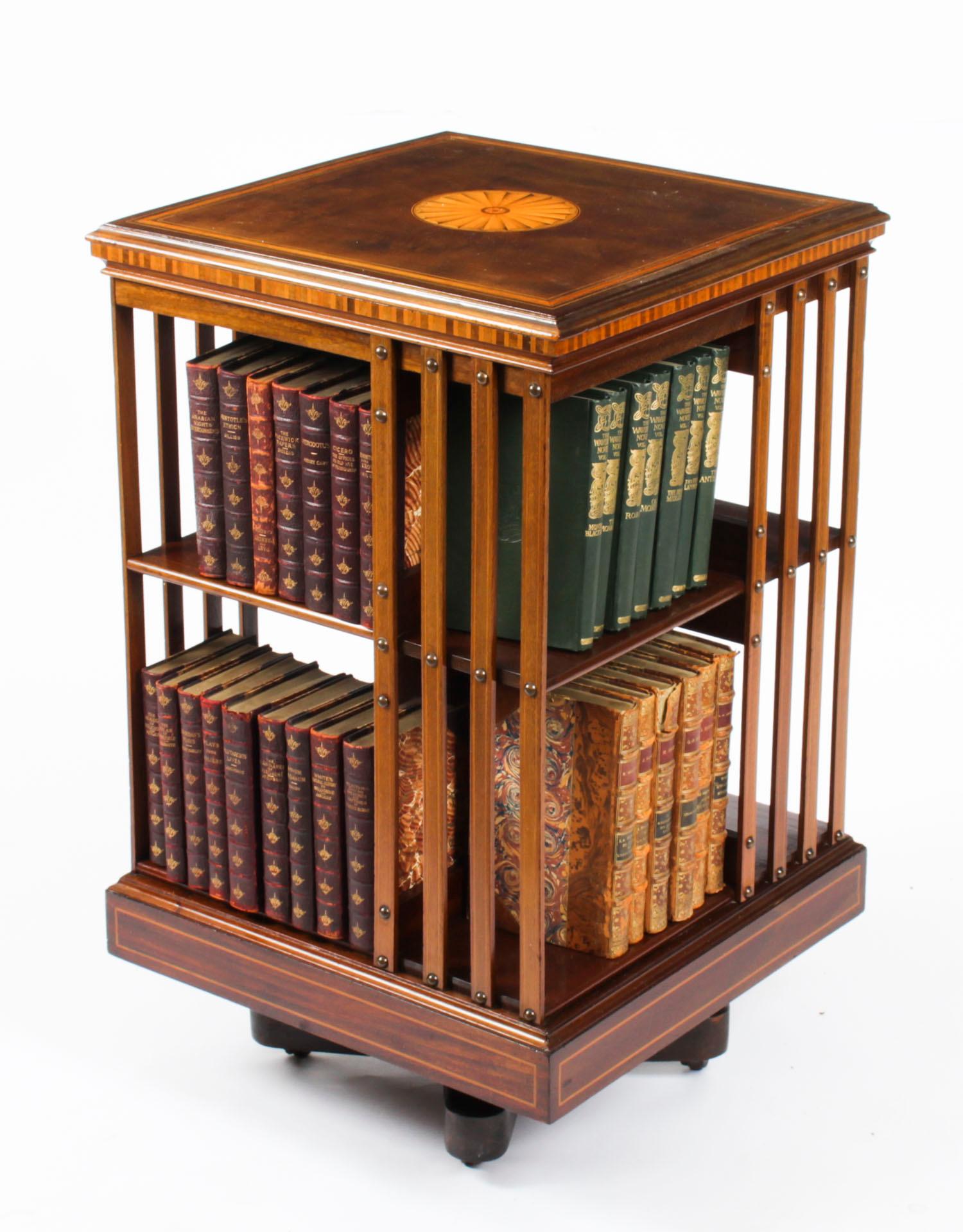 This an exquisite antique revolving bookcase attributed to the renowned Victorian retailer and manufacturer Maple & Co., circa 1900.

It is made of mahogany , revolves on a solid cast iron base, has inlaid boxwood lines to the top and bottom, the