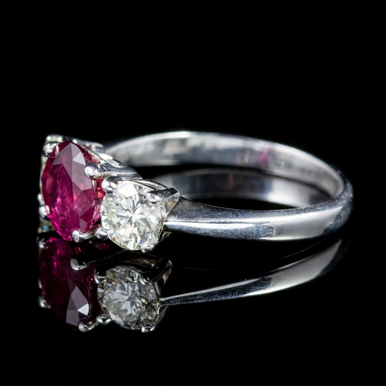 This striking antique trilogy ring features a gorgeous deep red 1.90ct natural Ruby flanked by two superb clarity Diamonds which are 0.60ct each and sparkle beautifully.   

A Trilogy of stones represents past, present and future or those 3 little