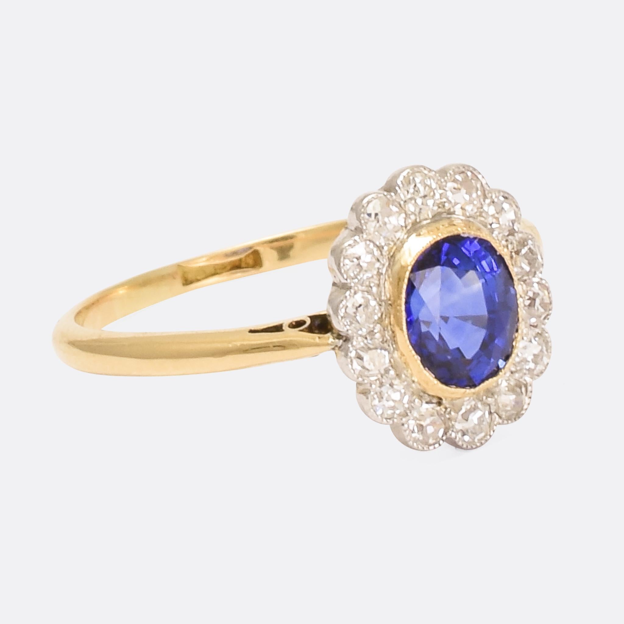 A stunning Edwardian period blue sapphire and diamond daisy ring, dating from circa 1910. The diamonds rest in immaculately worked millegrain platinum settings, giving them the appearance of white petals, and the sapphire displays excellent colour