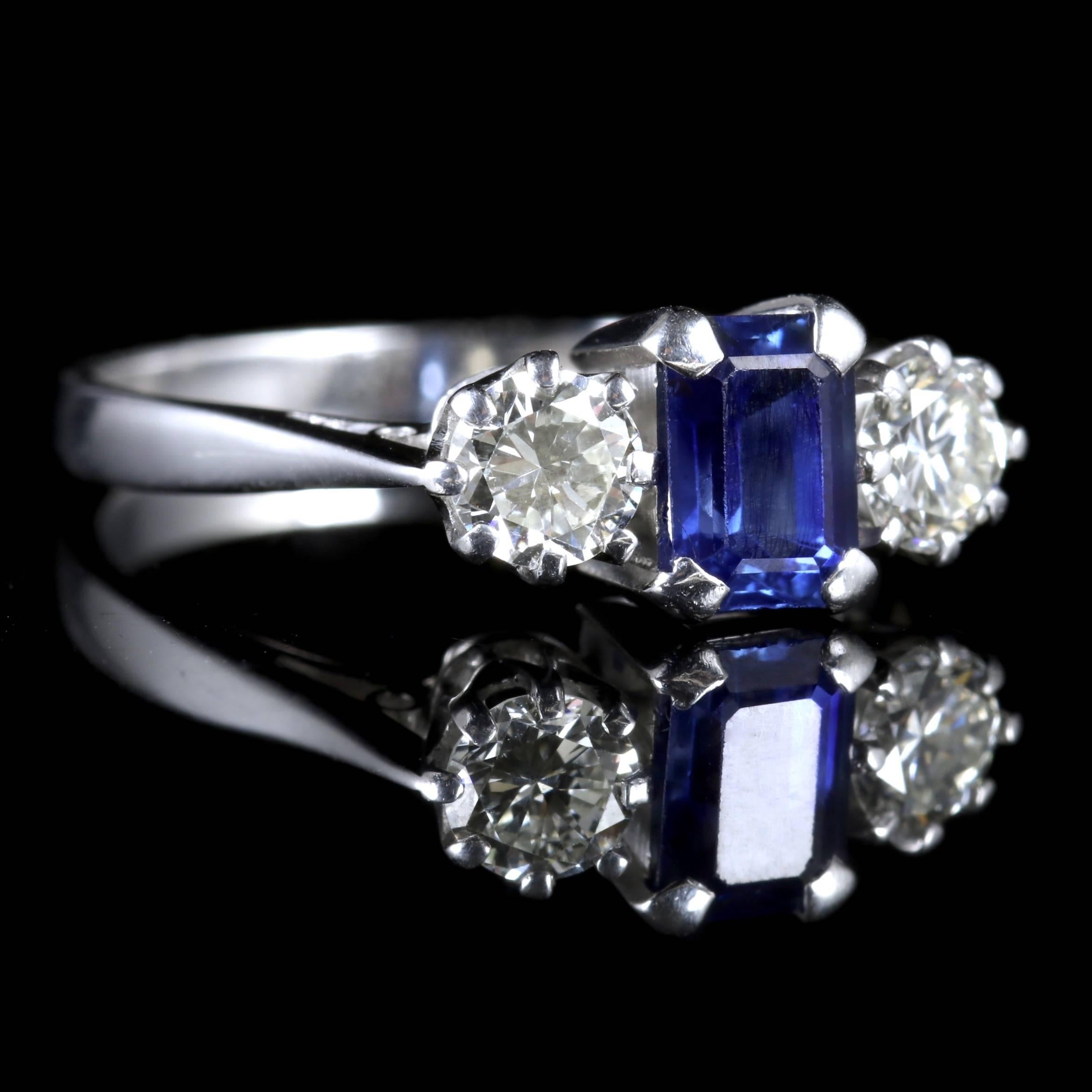 This elegant Edwardian Sapphire and Diamond trilogy ring is set in 18ct White Gold, Circa 1915.
 
The beautiful Sapphire is emerald cut with glistening old cut Diamonds.

The central Sapphire is approx 0.80ct and the Diamonds at either side are