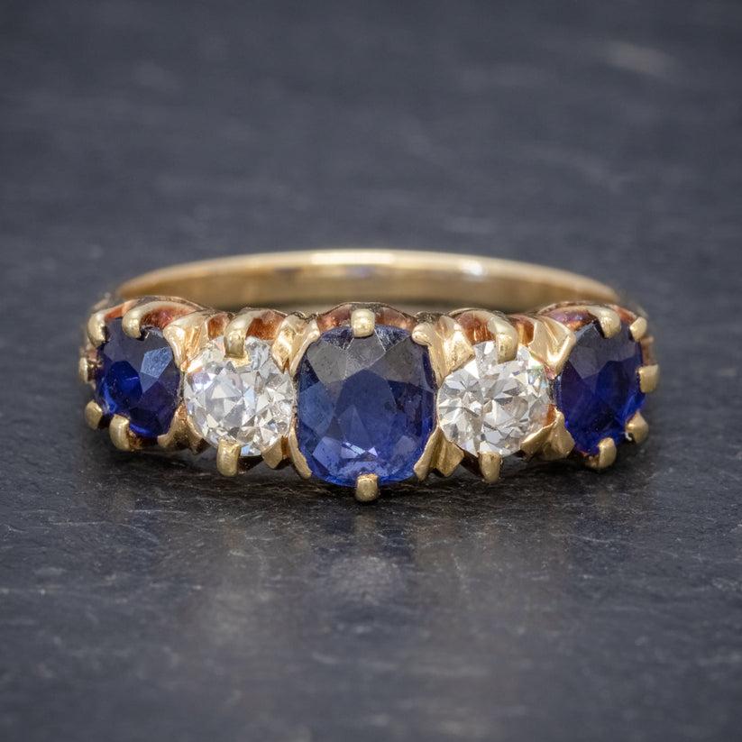 A magnificent antique Edwardian ring modelled in 18ct gold and claw set with three vibrant blue sapphires, the largest of which is approx. 0.70ct in the centre flanked by two 0.25ct stones at each end (approx. 1.20ct total).

The sapphires are