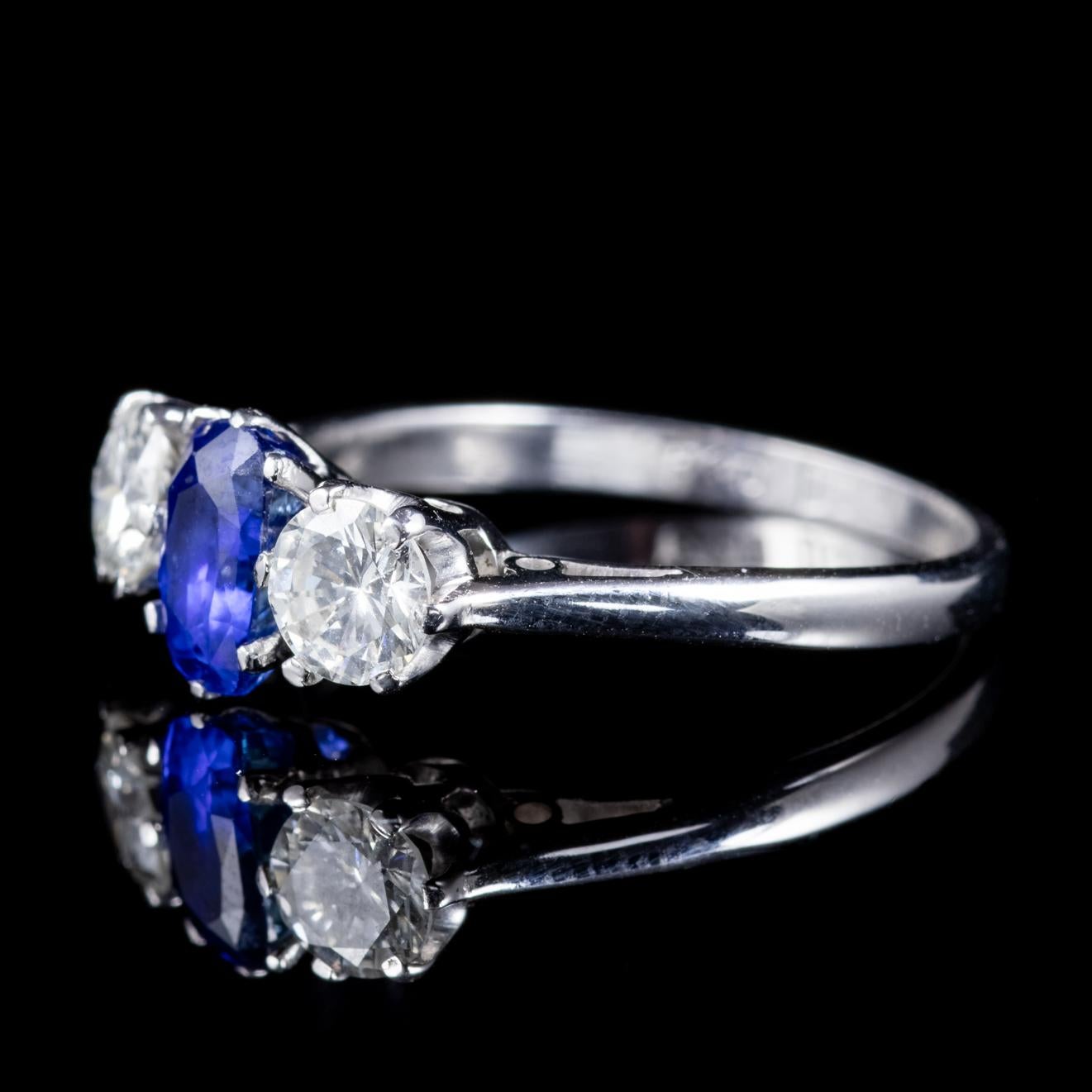 A stunning antique Edwardian trilogy ring boasting a lovely deep blue 0.60ct Sapphire flanked by two 0.40ct superb clarity Brilliant cut Diamonds. The deep royal blue of the Sapphire has been a favourite of kings and royalty throughout history and