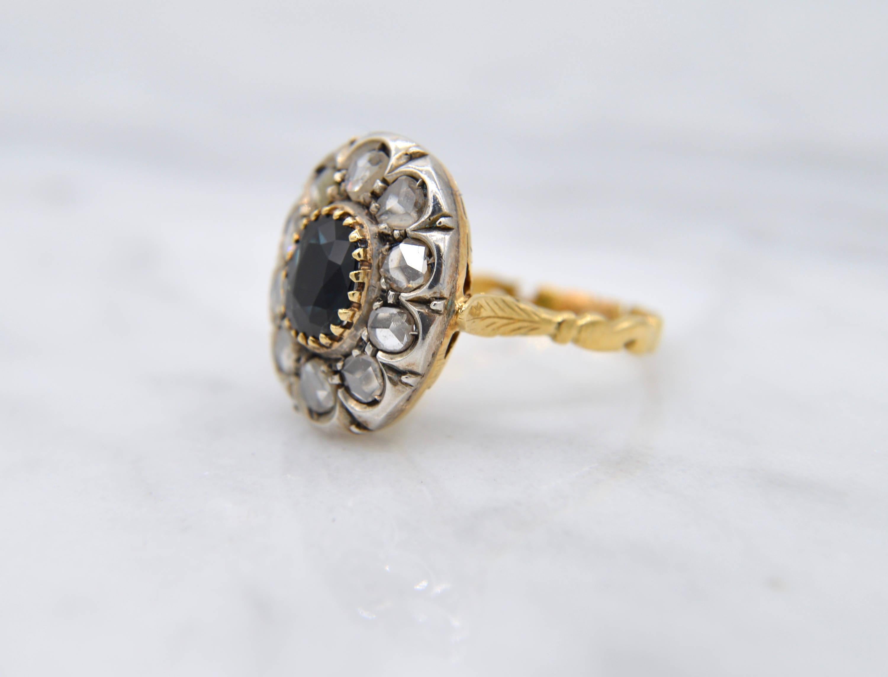 Gorgeous antique Edwardian era circa 1905-1910 2.3 carat natural genuine sapphire surrounded by 10 gorgeous sparking rosecut genuine diamonds that measure 3mm (.11 carat) each. 18K yellow gold shank with silver setting. Marked as 750 for solid 18K.