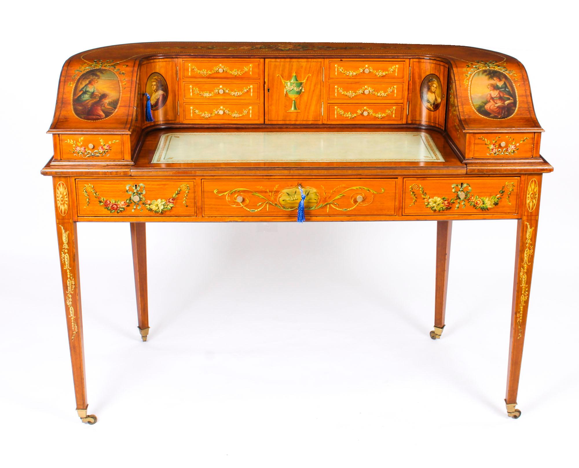 This is a truly exceptional antique Edwardian hand painted and inlaid satinwood Carlton House desk, circa 1900 in date.

This stunning desk is made from the finest satinwood, and it is superbly finished all round with spectacular hand painted floral
