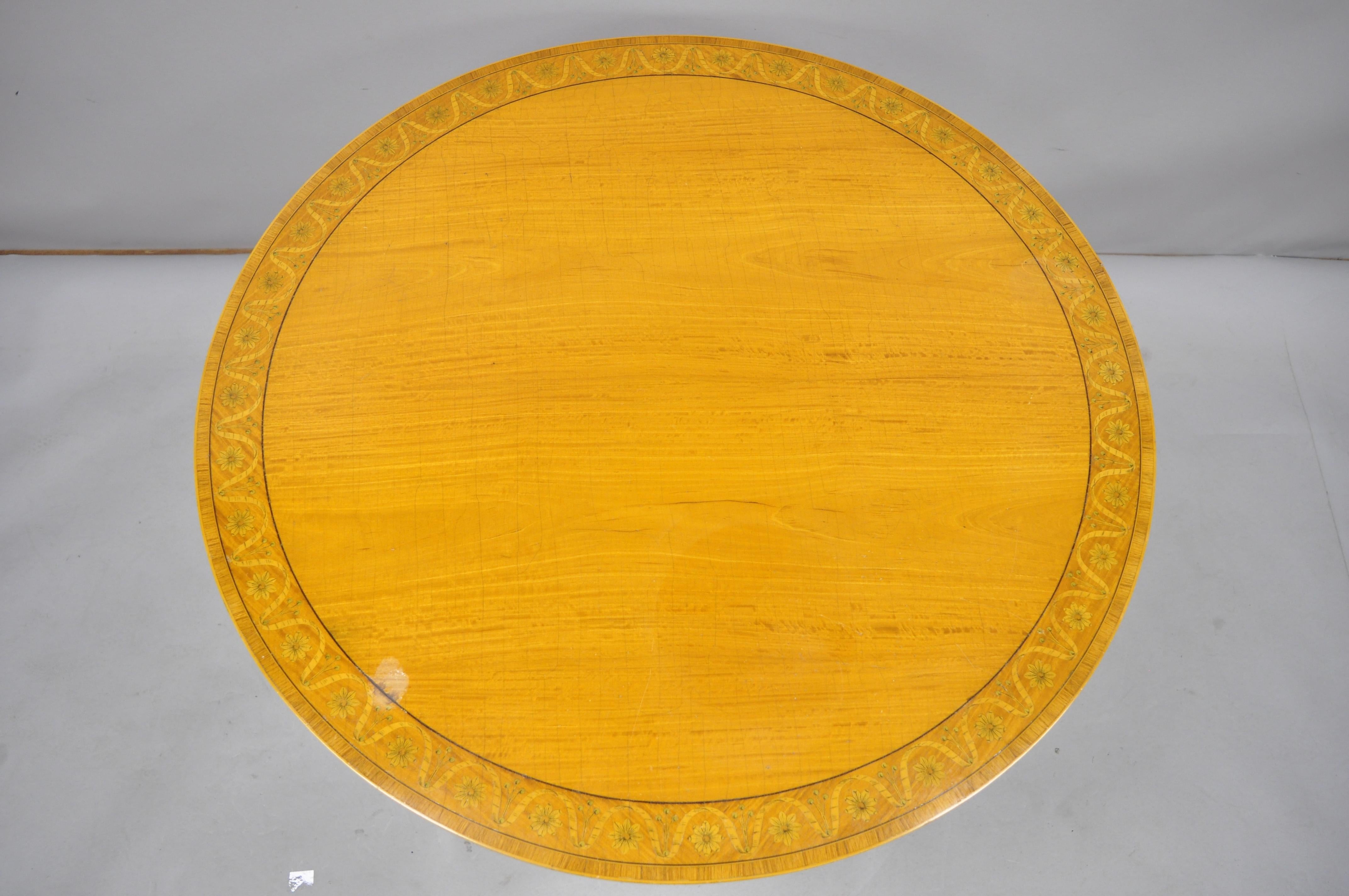 Antique Edwardian satinwood inlaid round banded center breakfast table. Listing features pencil inlay, banded top, ribbon and floral inlay, tapered legs, very nice antique item. Great for use as a center/game table or small breakfast table, circa