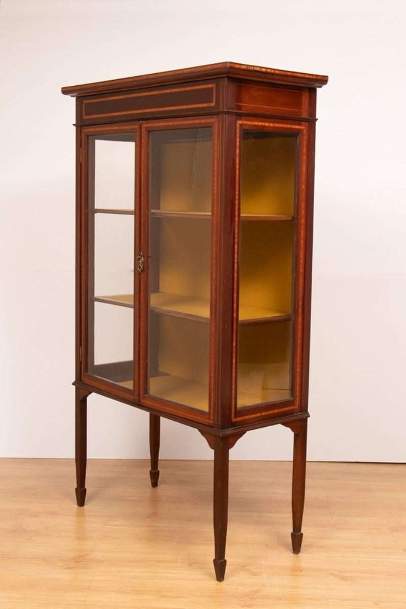 An antique Edwardian Sheraton revival display cabinet constructed with high-quality mahogany with extensive inlay and original French polished finish. Original functioning lock and key.