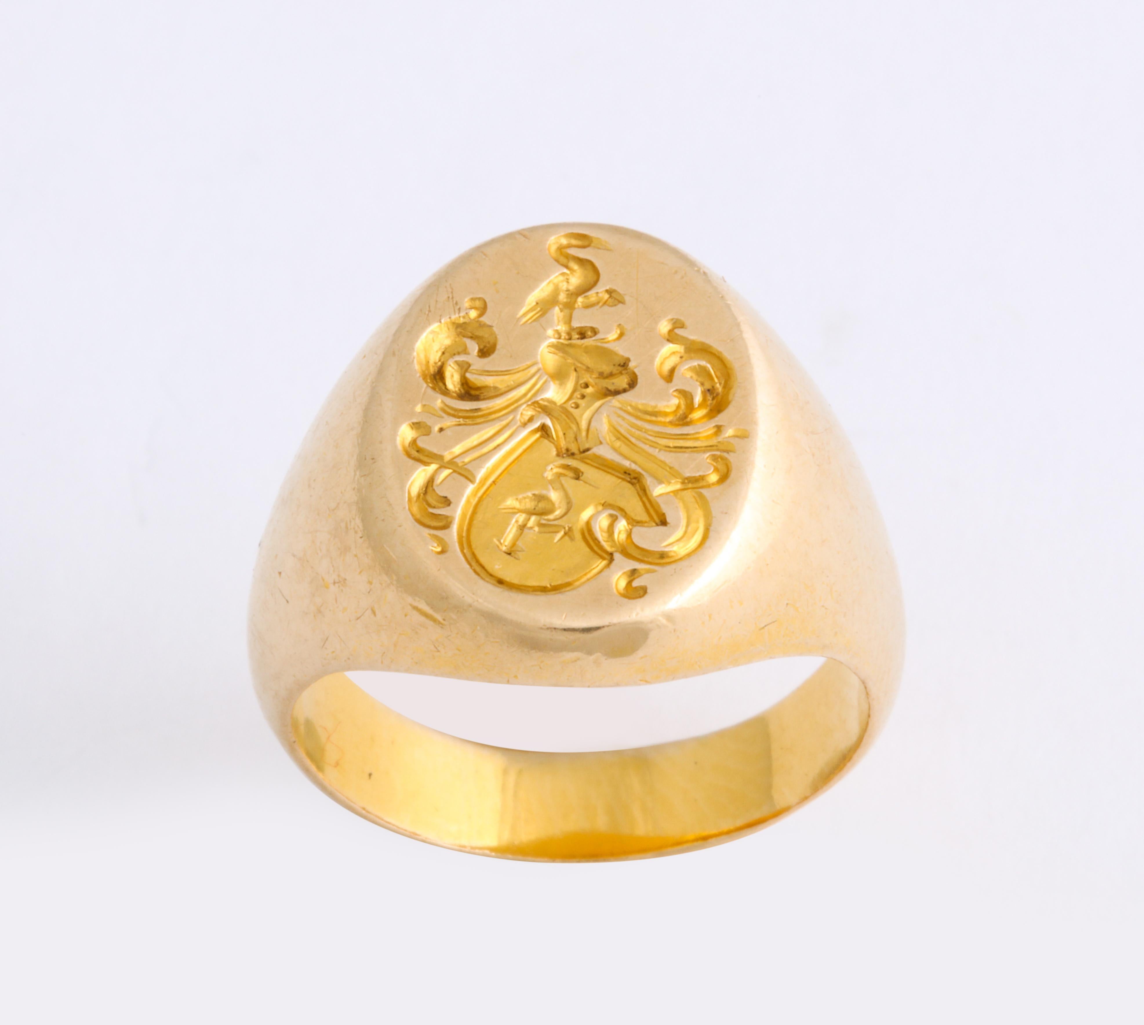 A signet ring in 14 Kt Gold clearly depicts two storks balanced on one leg, one bird within a shield, the other above a plumed knight's helmet. The pleasure of the positive symbolism attached to storks, aside from balance, is wisdom, intelligence,