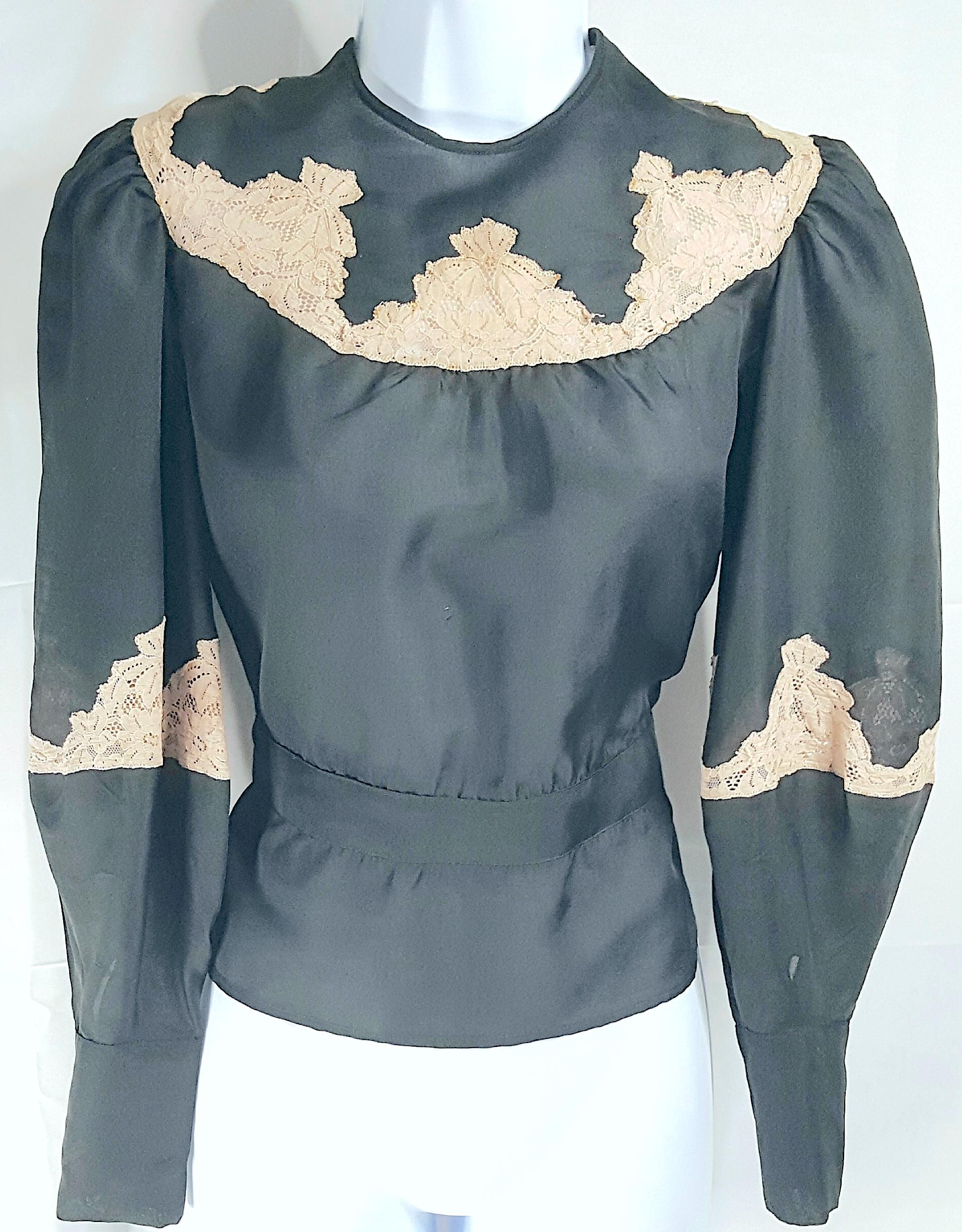 This antique Italian couture semi-transparent black silk-organza long-balloon-sleeved peplum blouse from the Victorian Edwardian period features decorative cut-work with topstitched lettuce-edged ecru lace inserts, which ventilate the arms and