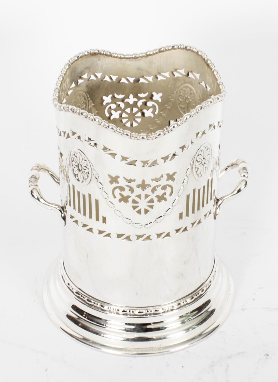 An attractive English  antique silver plated bottle holder, circa 1910 and bearing the makers mark.
  
The attention to detail exhibited by this  silversmith is absolutely fantastic, with superb engraved and cut decoration.
  
Add a touch of class