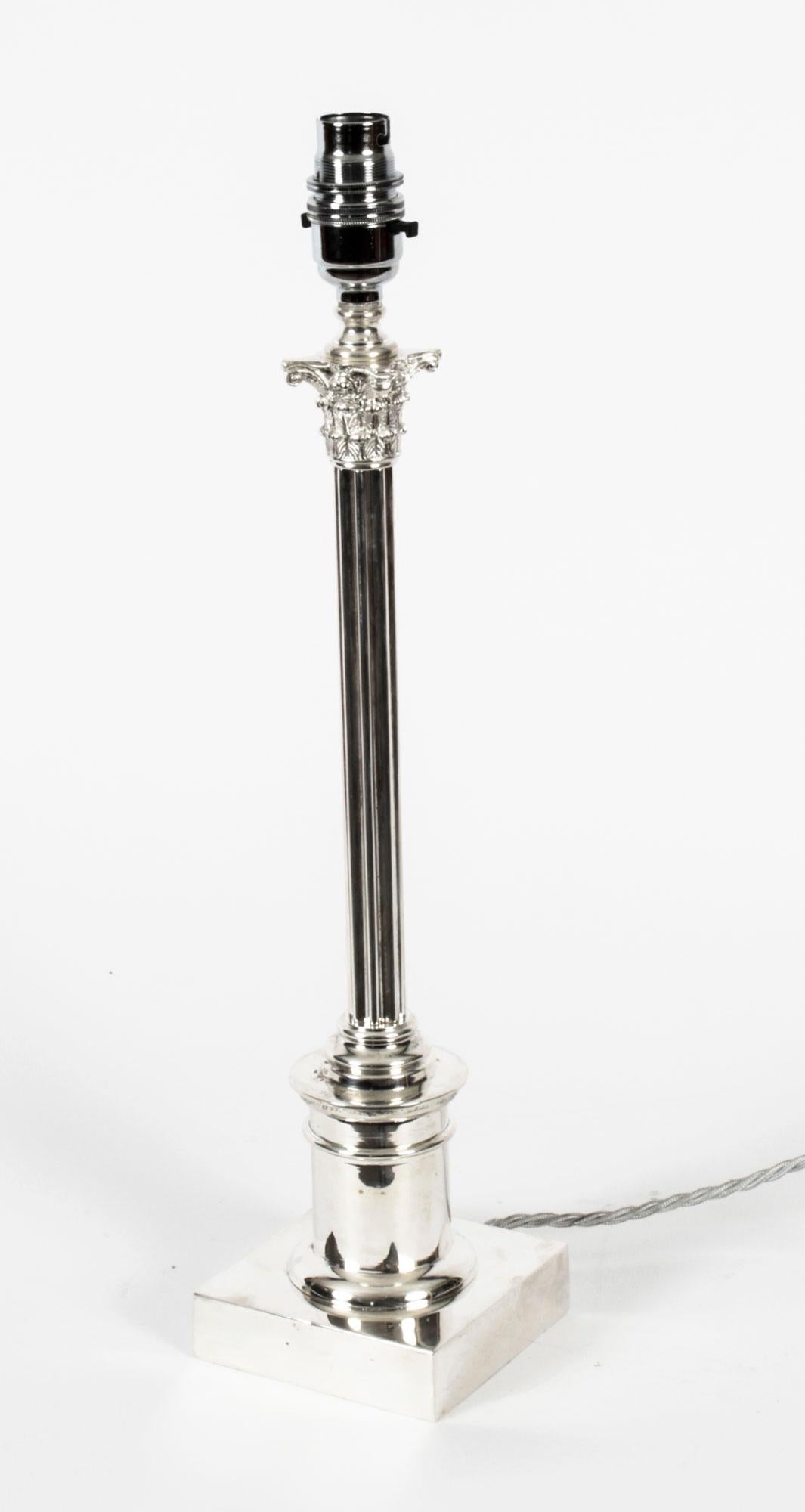 This is an impressive antique Edwardian silver plated Corinthian column table lamp, circa 1910 in date.
 
It features a classic Corinthian Capital decorated with acanthus leaves and anthemion with a thin cylindrical fluted shaft on a circular