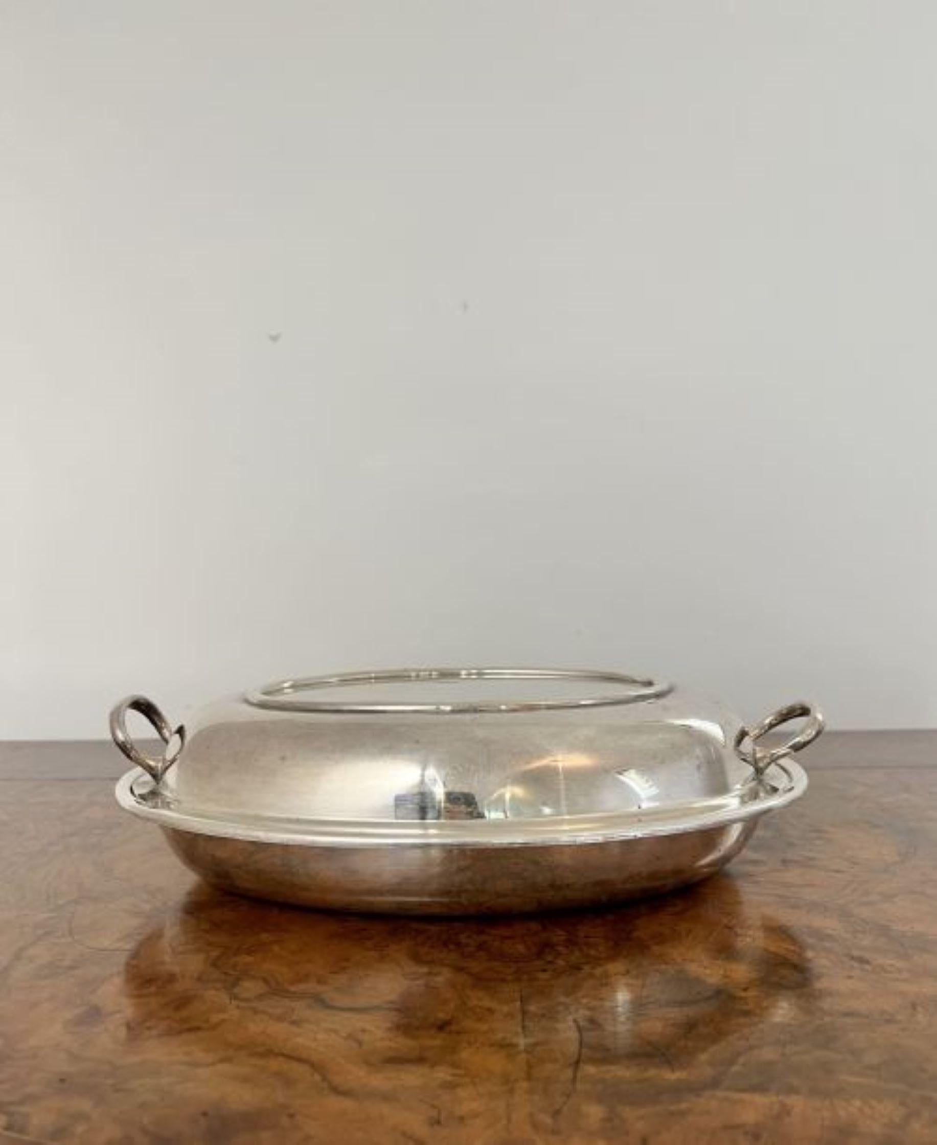 Antique Edwardian silver plated oval entree dish having an antique Edwardian oval shaped entree dish with handles to both sides and a removable lid. 
