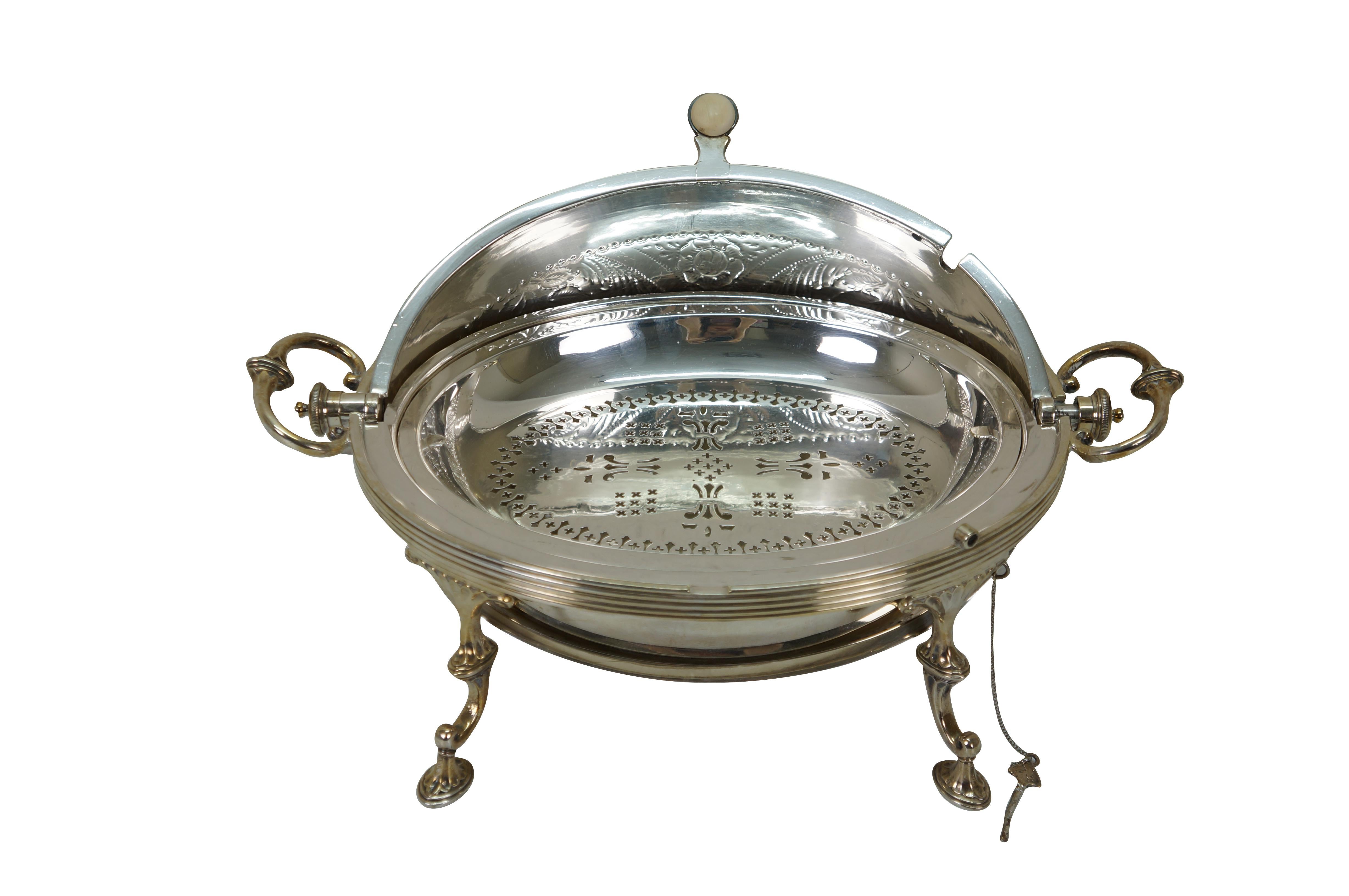 Late 19th to early 20th century English Victorian / Edwardian silver revolving / rotating dome top serving / chafing / warming food dish. Oval, egg shaped dome shaped dish with four 'C' scroll legs, two side handles, and white handle. To one side is