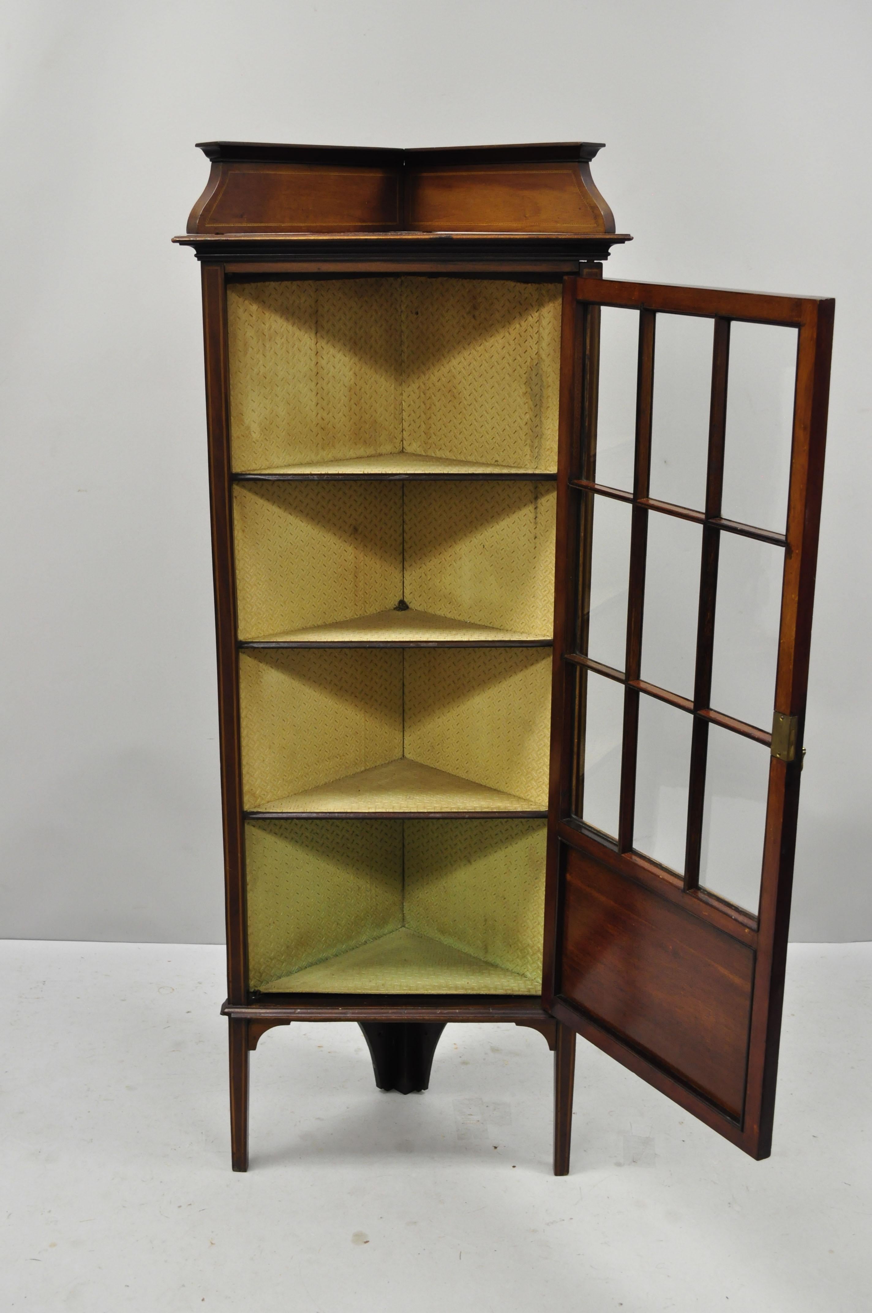 Antique Edwardian small corner display cabinet inlaid curio. Item features individual panes of glass, small petite size, beautiful wood grain, 1 swing door, no key but unlocked, very nice antique item. Early 1900s. Measurements: 56.5