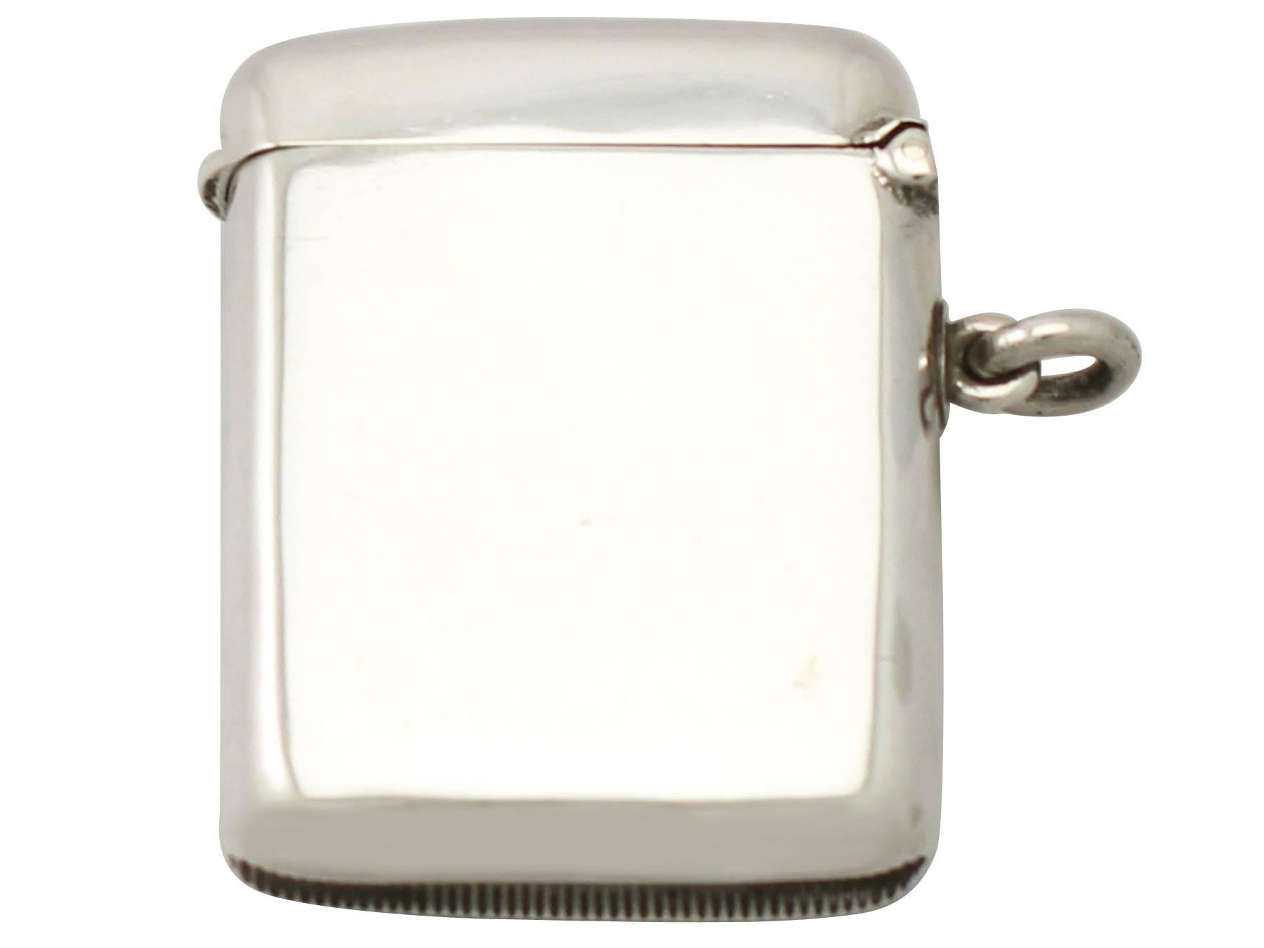 A fine and impressive antique Edwardian English sterling silver and enamel vesta case; an addition to our enamel and silver collection

This fine antique sterling silver vesta case has a plain rectangular rounded form.

The anterior surface is