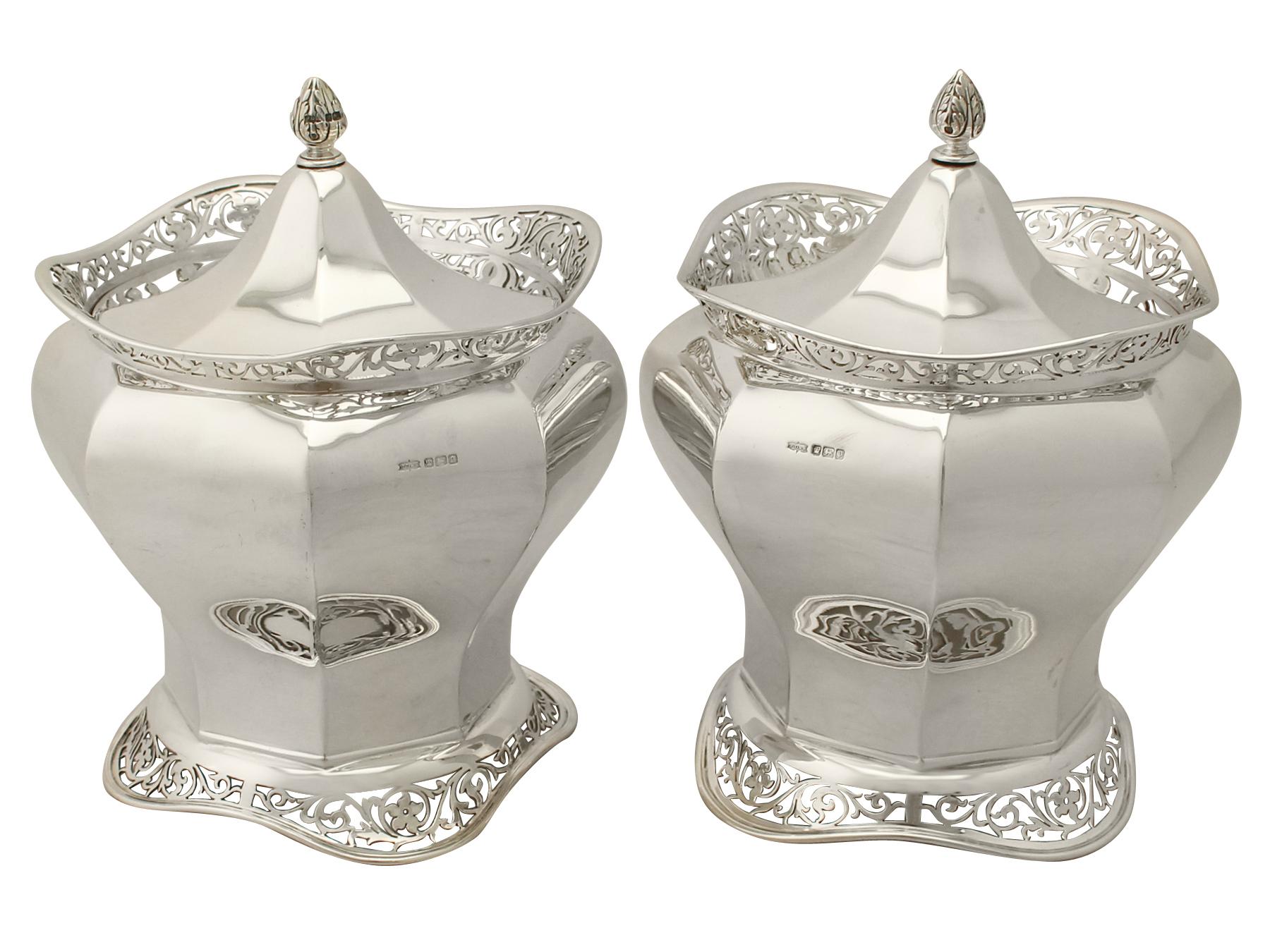 An exceptional, fine and impressive pair of antique Edwardian English sterling silver biscuit boxes; an addition to our silver teaware collection.

These exceptional antique Edwardian sterling silver biscuit boxes have a plain hexagonal panelled