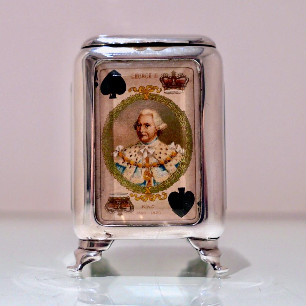 An incredibly rare and extremely stylish Edwardian silver “picture” card box. The hinged lid is typically plain formed in design, however the walls of the box each have a suite of cards framed behind a beveled glass panel for decorative creativity.